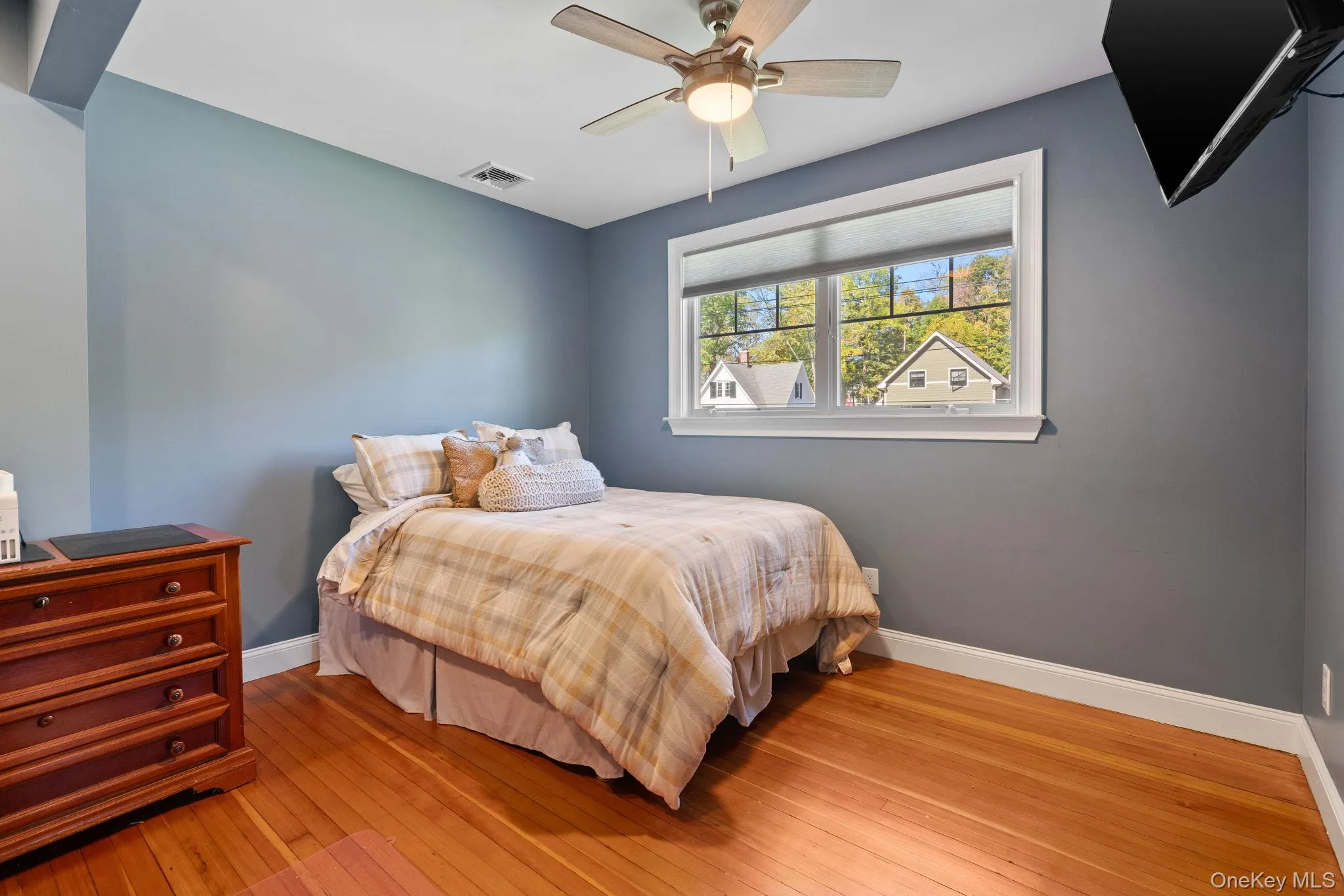Bedroom with light wood-style floors and ceiling fan Bedroom with light wood-style floors and ceiling fan