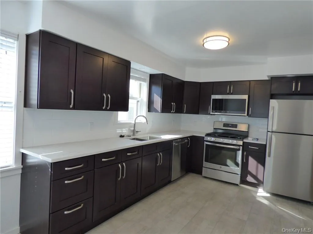 Kitchen featuring backsplash, light countertops, stainless steel appliances Kitchen featuring backsplash, light countertops, stainless steel appliances