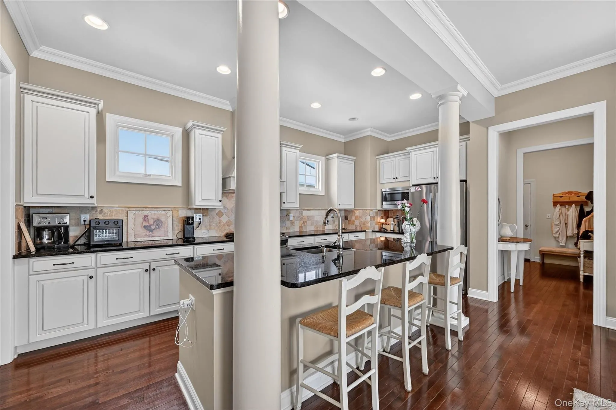 Spacious kitchen with granite counters, island seating, and abundant cabinet and prep space. Spacious kitchen with granite counters, island seating, and abundant cabinet and prep space.