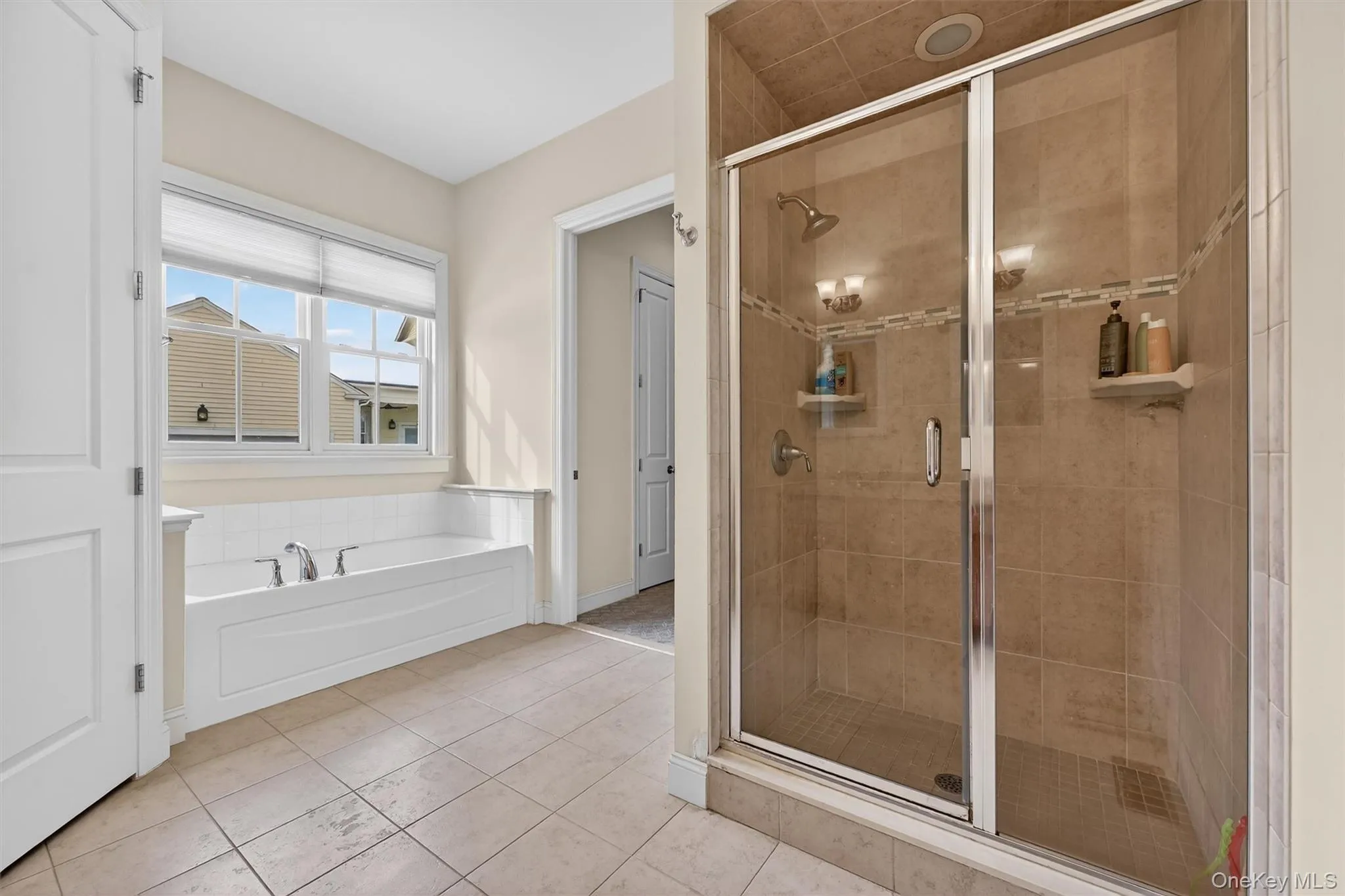 Spa-inspired primary bath with soaking tub, glass-enclosed shower, and private water closet. Spa-inspired primary bath with soaking tub, glass-enclosed shower, and private water closet.