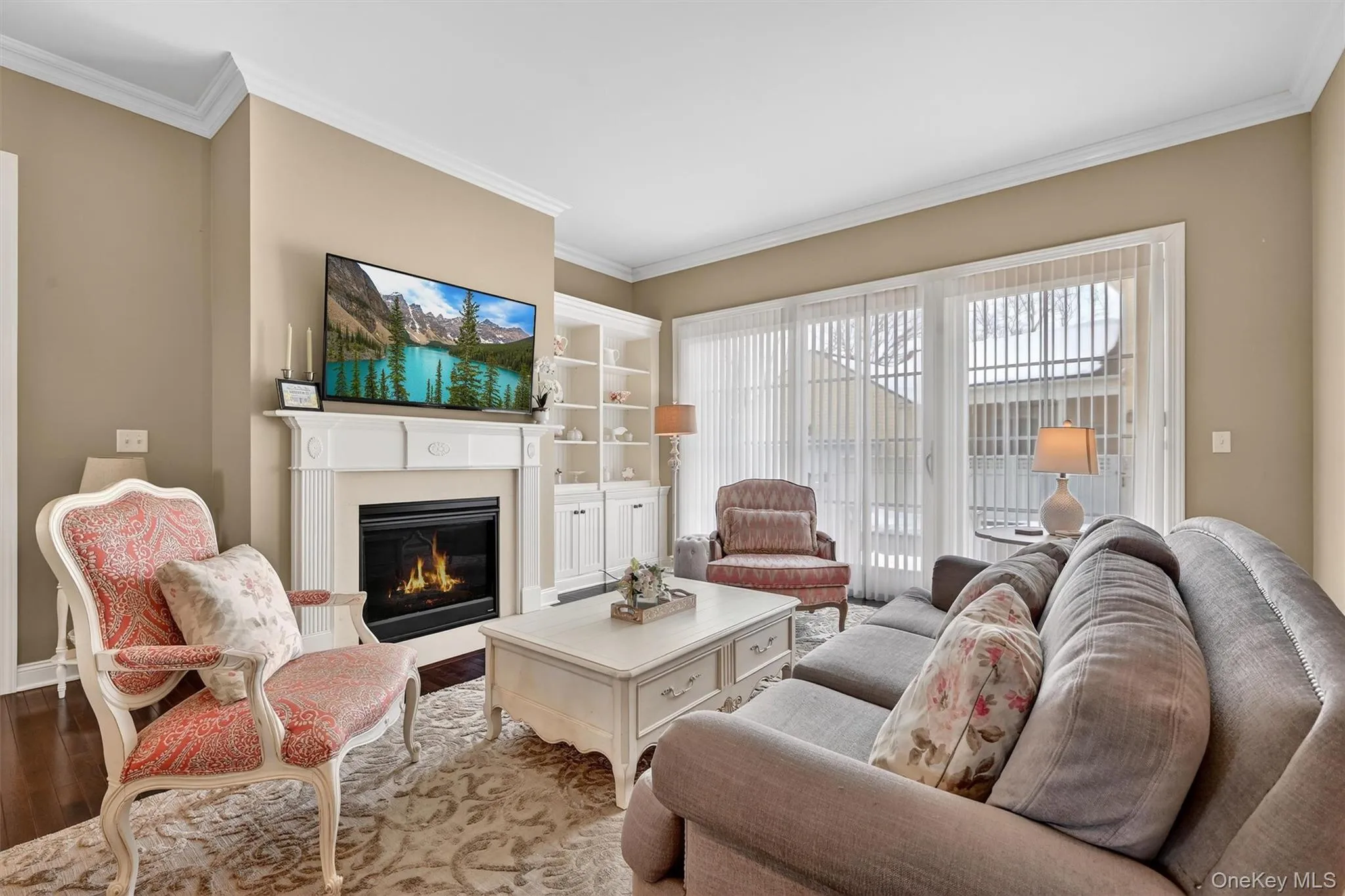 Comfortable living room featuring a gas fireplace and seamless access to the private patio. Comfortable living room featuring a gas fireplace and seamless access to the private patio.
