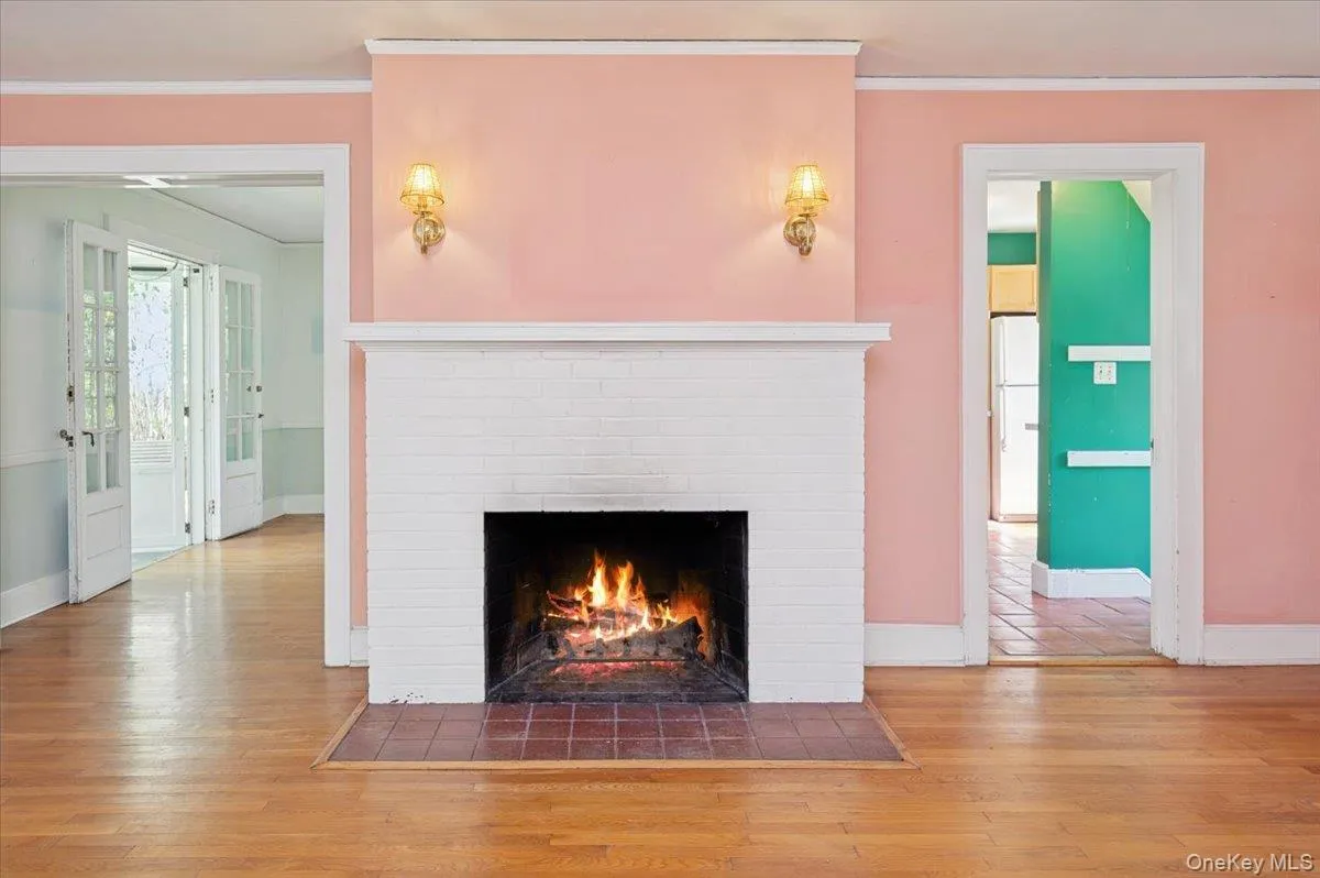 Living room with hardwood floors, wood burning fireplace and mantle Living room with hardwood floors, wood burning fireplace and mantle