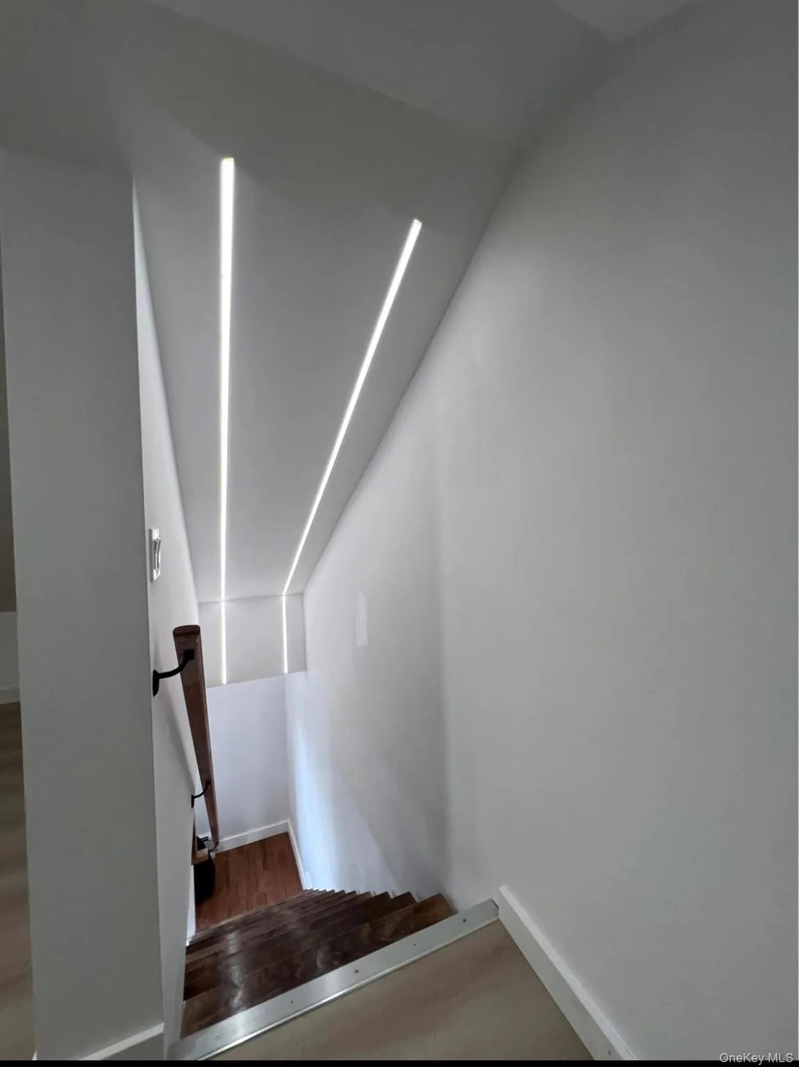 Stairs featuring baseboards and wood finished floors Stairs featuring baseboards and wood finished floors