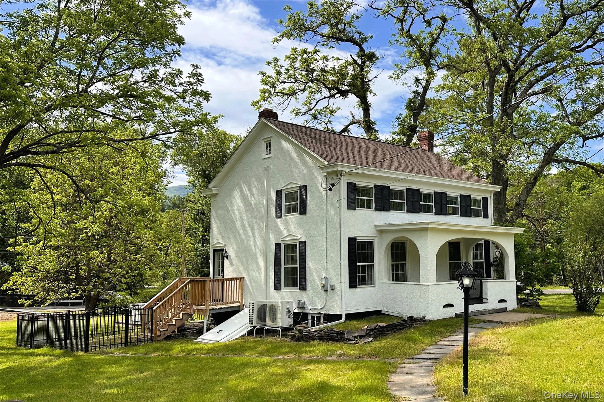 Farm house with porch and fenced yard Farm house with porch and fenced yard