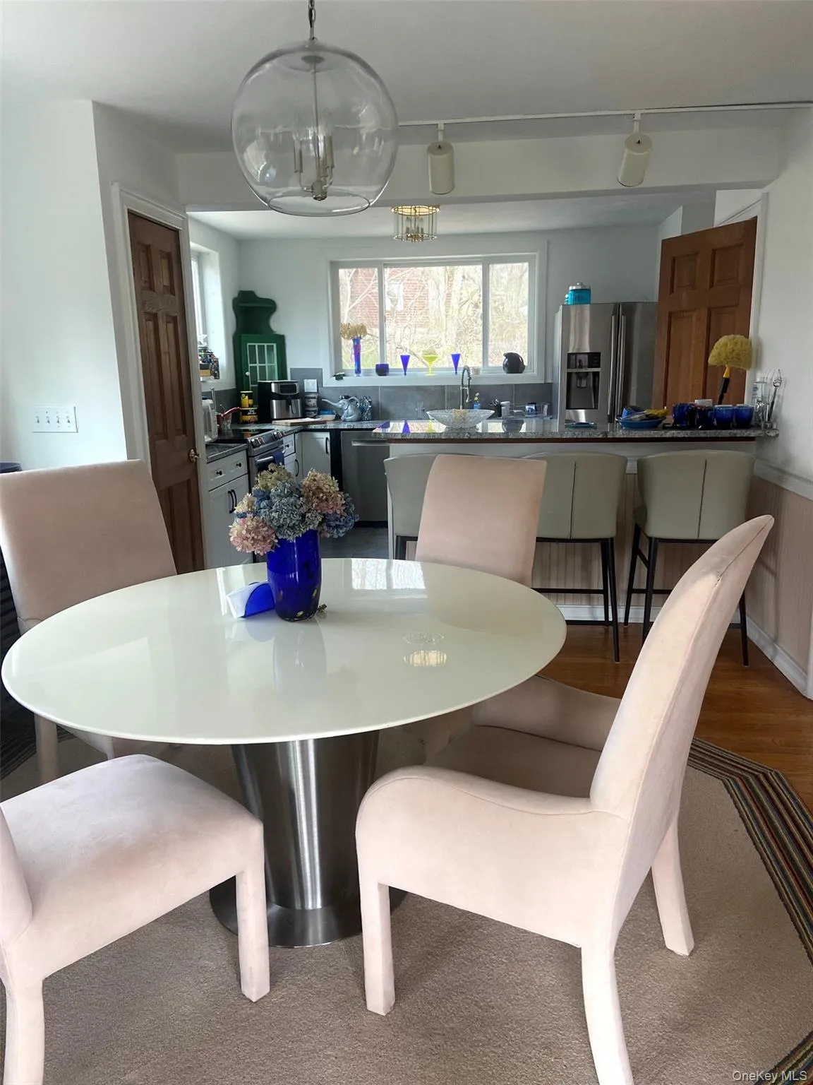 Dining space with a chandelier, wainscoting, and wood finished floors Dining space with a chandelier, wainscoting, and wood finished floors