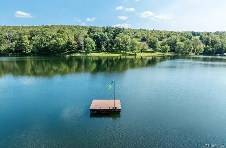 View of dock with a forest view and a water view View of dock with a forest view and a water view