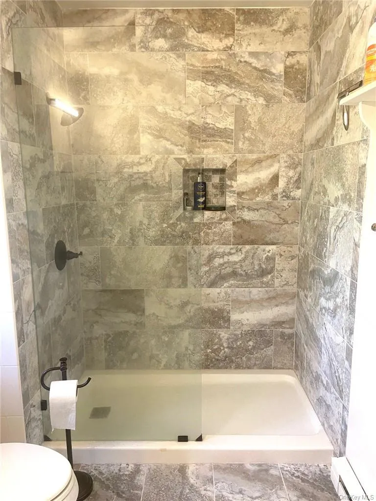 Bathroom with a tile shower Bathroom with a tile shower