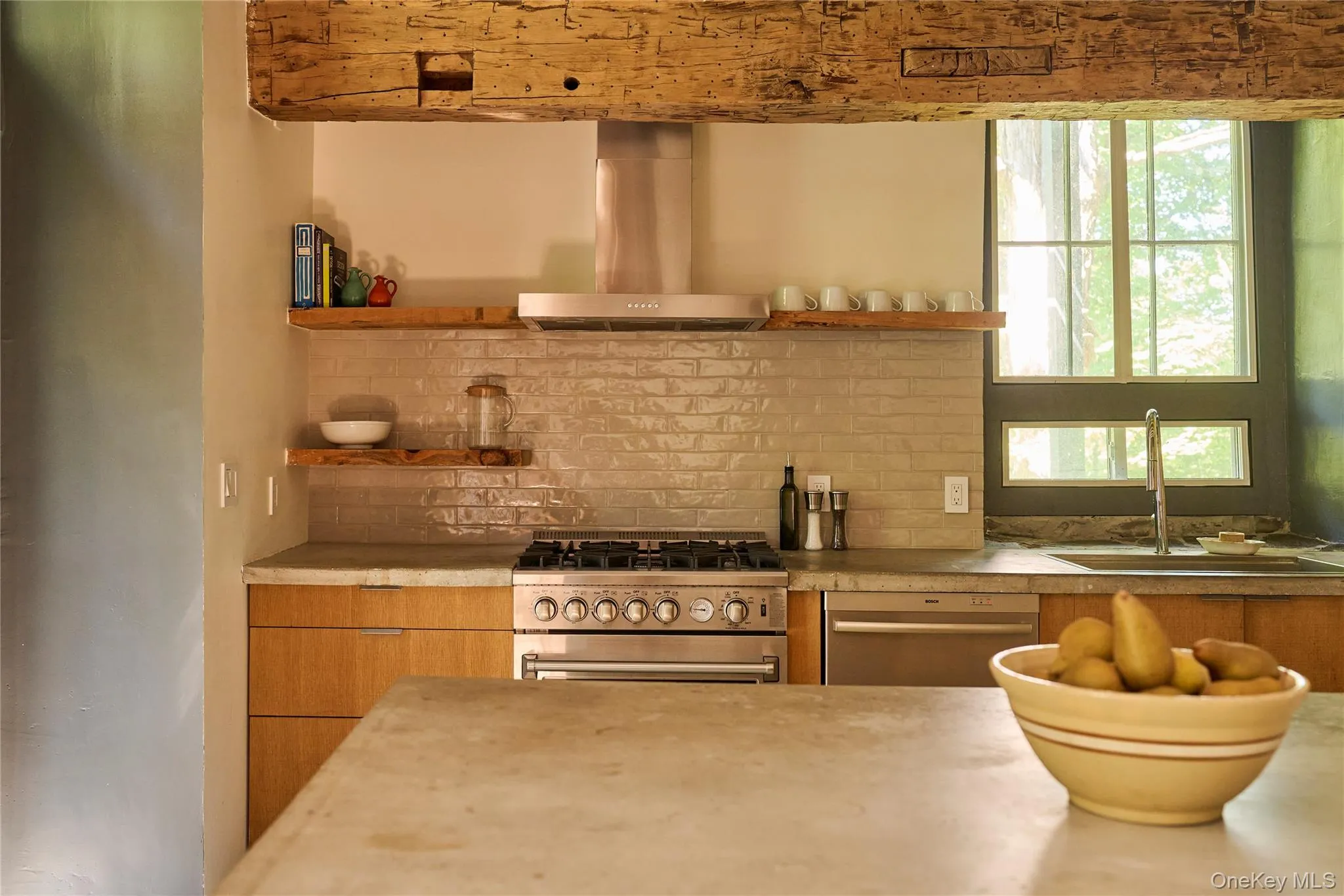 Kitchen featuring range hood, open shelves, stainless steel appliances, light countertops, and modern cabinets Kitchen featuring range hood, open shelves, stainless steel appliances, light countertops, and modern cabinets