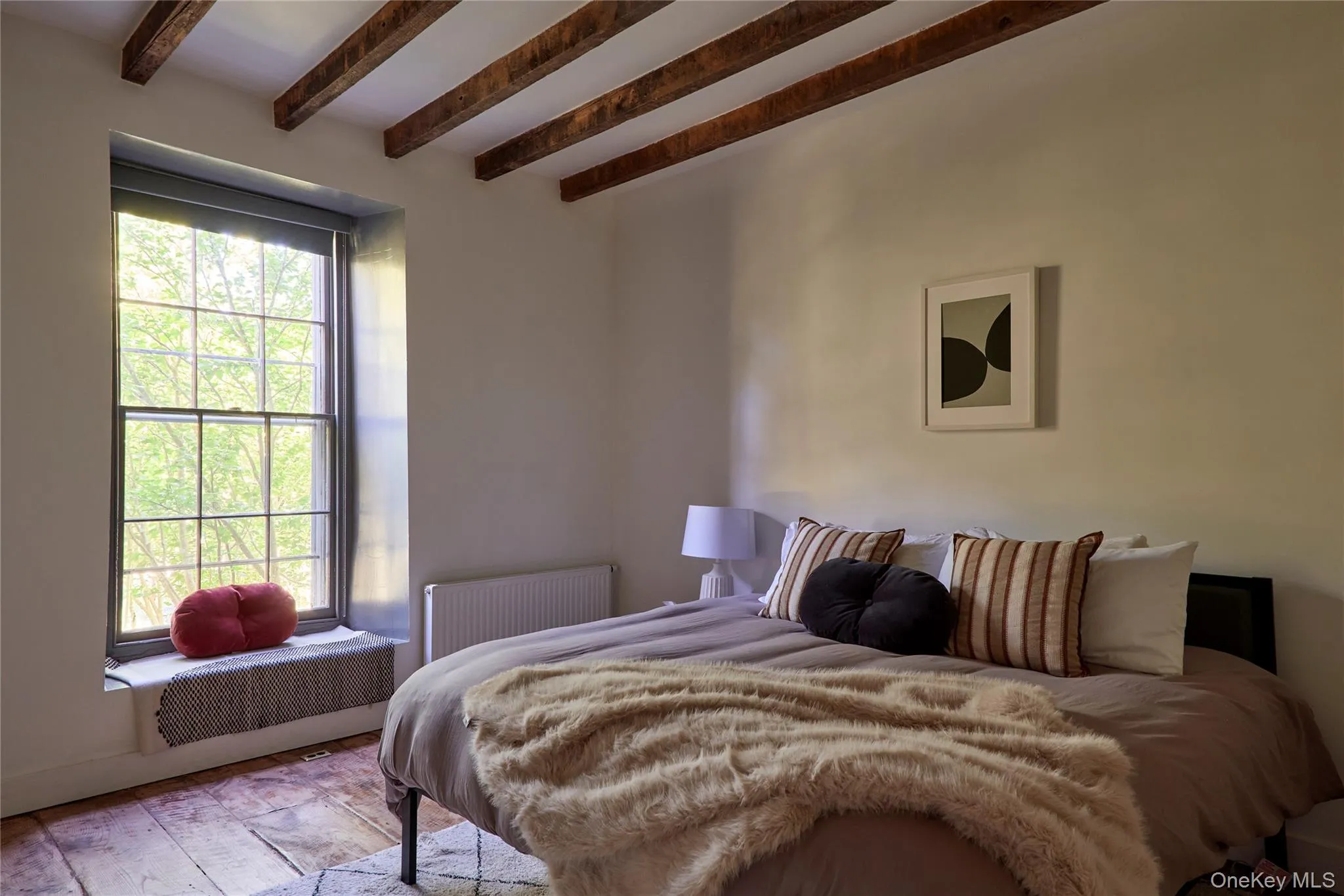 Bedroom featuring radiator heating unit and beamed ceiling Bedroom featuring radiator heating unit and beamed ceiling
