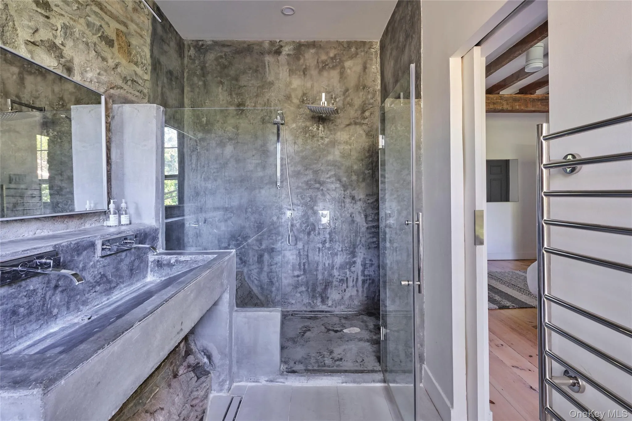 Bathroom featuring a marble finish shower and vanity Bathroom featuring a marble finish shower and vanity