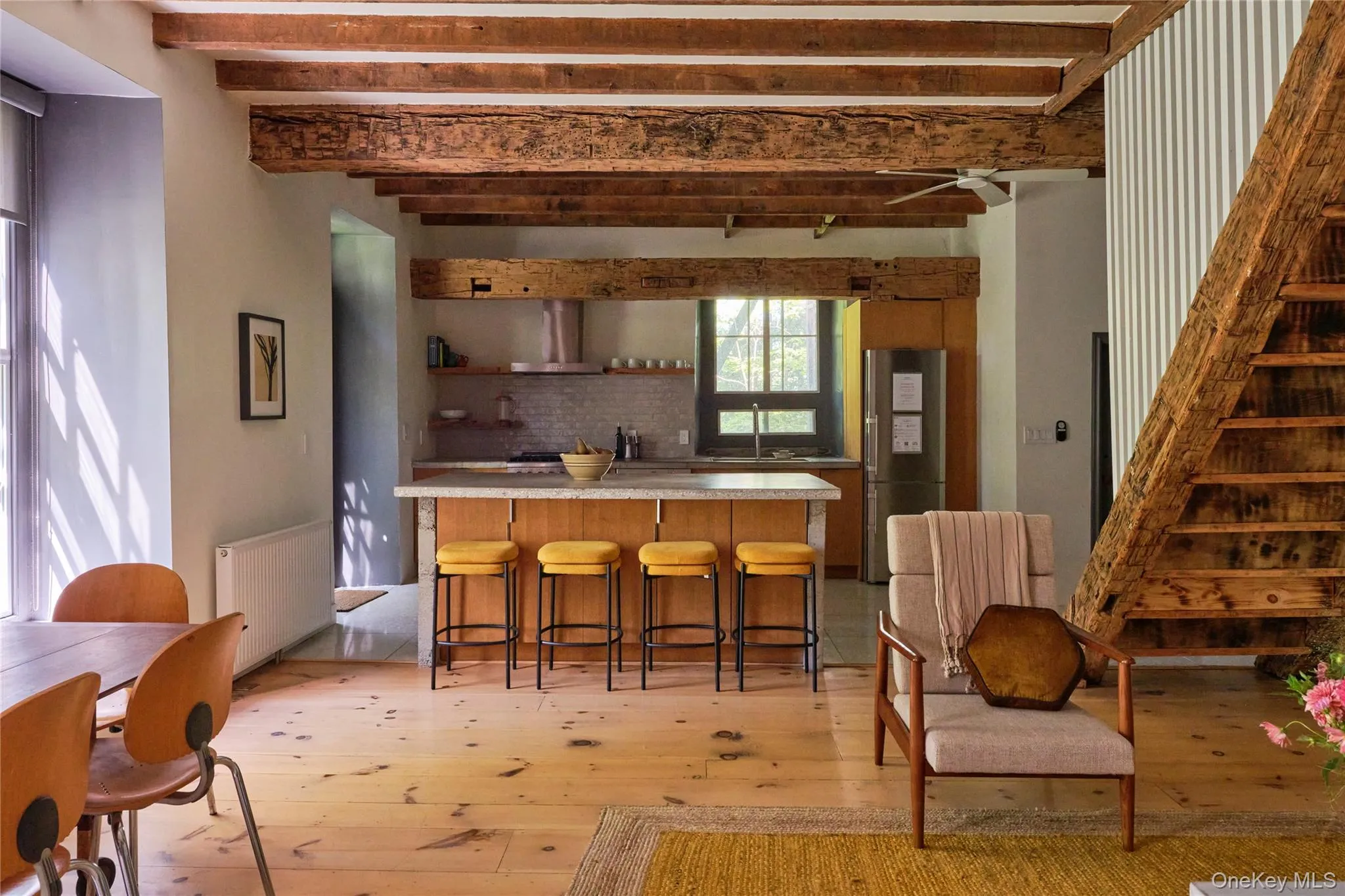 Kitchen with light countertops, radiator heating unit, open shelves, beam ceiling, and freestanding refrigerator Kitchen with light countertops, radiator heating unit, open shelves, beam ceiling, and freestanding refrigerator