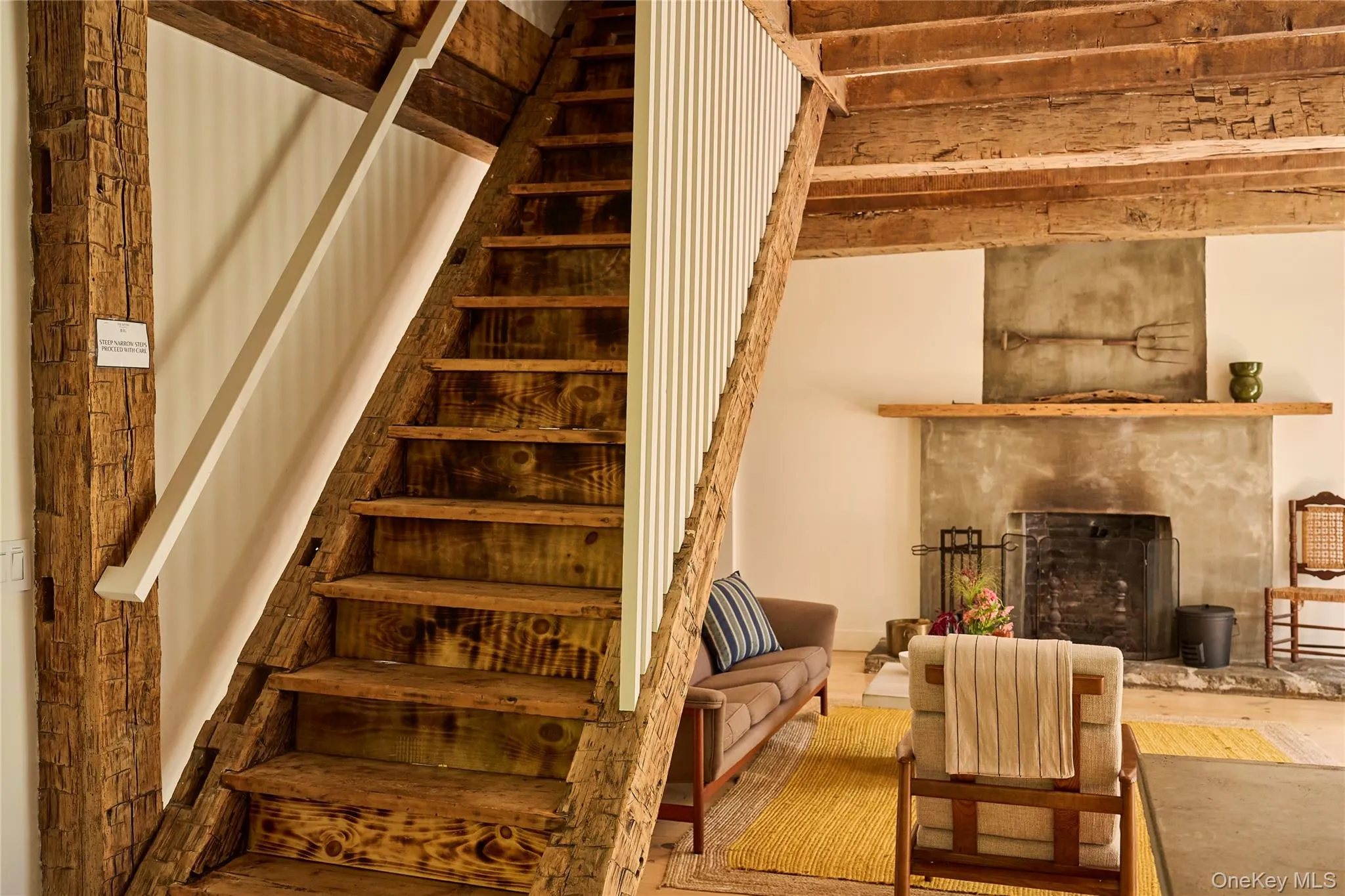 Staircase with a high end fireplace and wood finished floors Staircase with a high end fireplace and wood finished floors