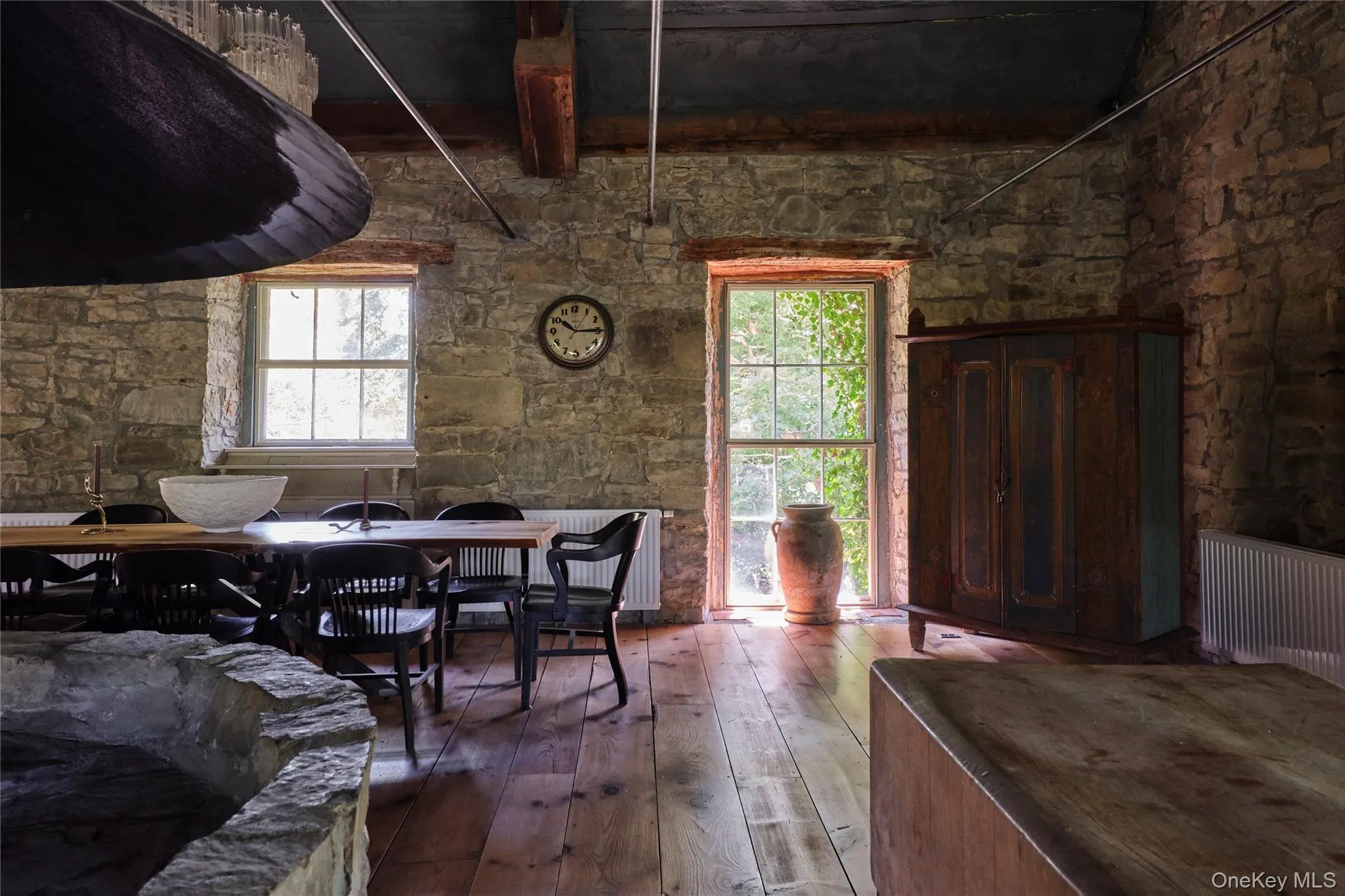Dining area with hardwood / wood-style floors and radiator Dining area with hardwood / wood-style floors and radiator