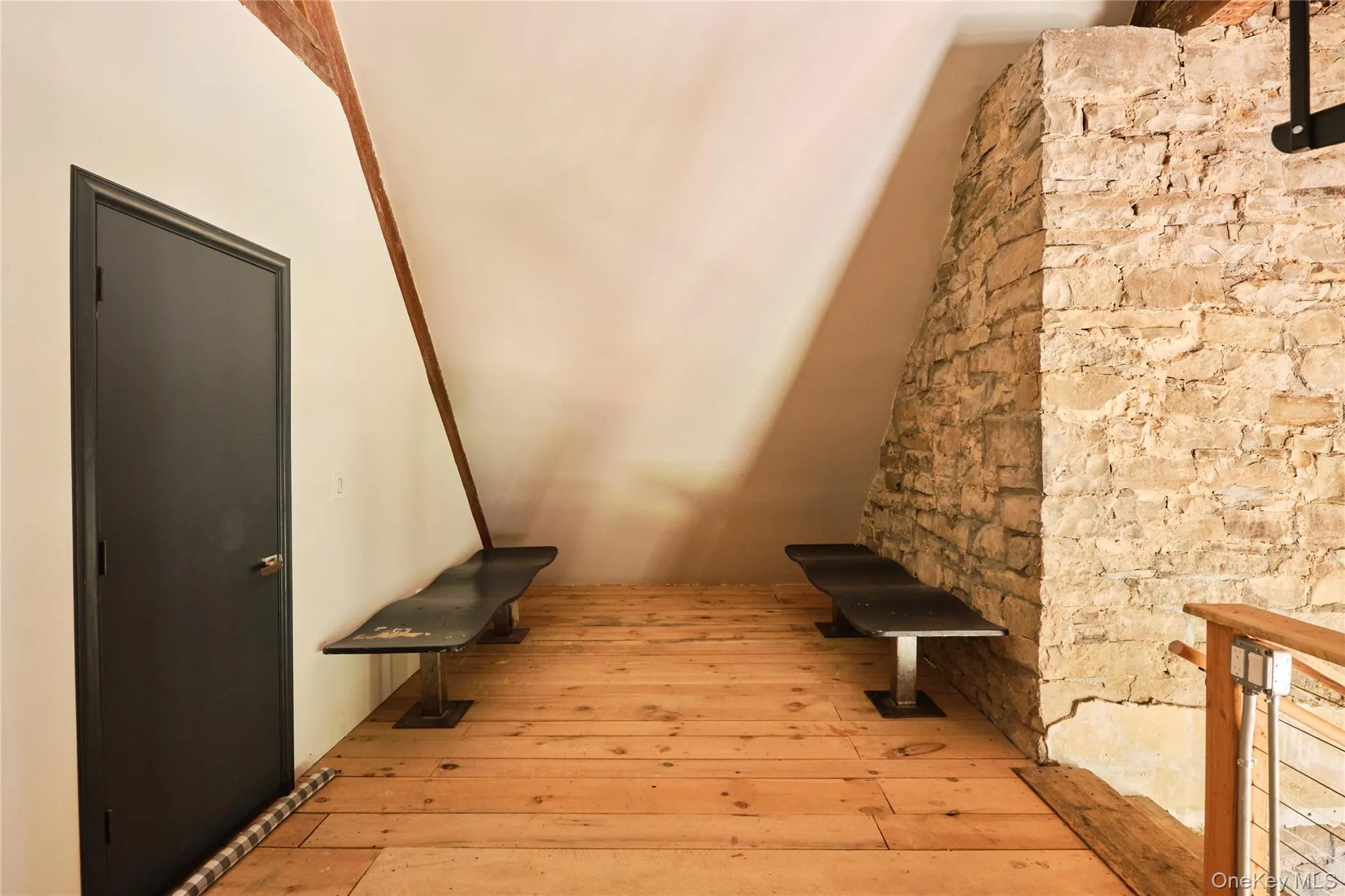 Stairway featuring hardwood / wood-style flooring Stairway featuring hardwood / wood-style flooring