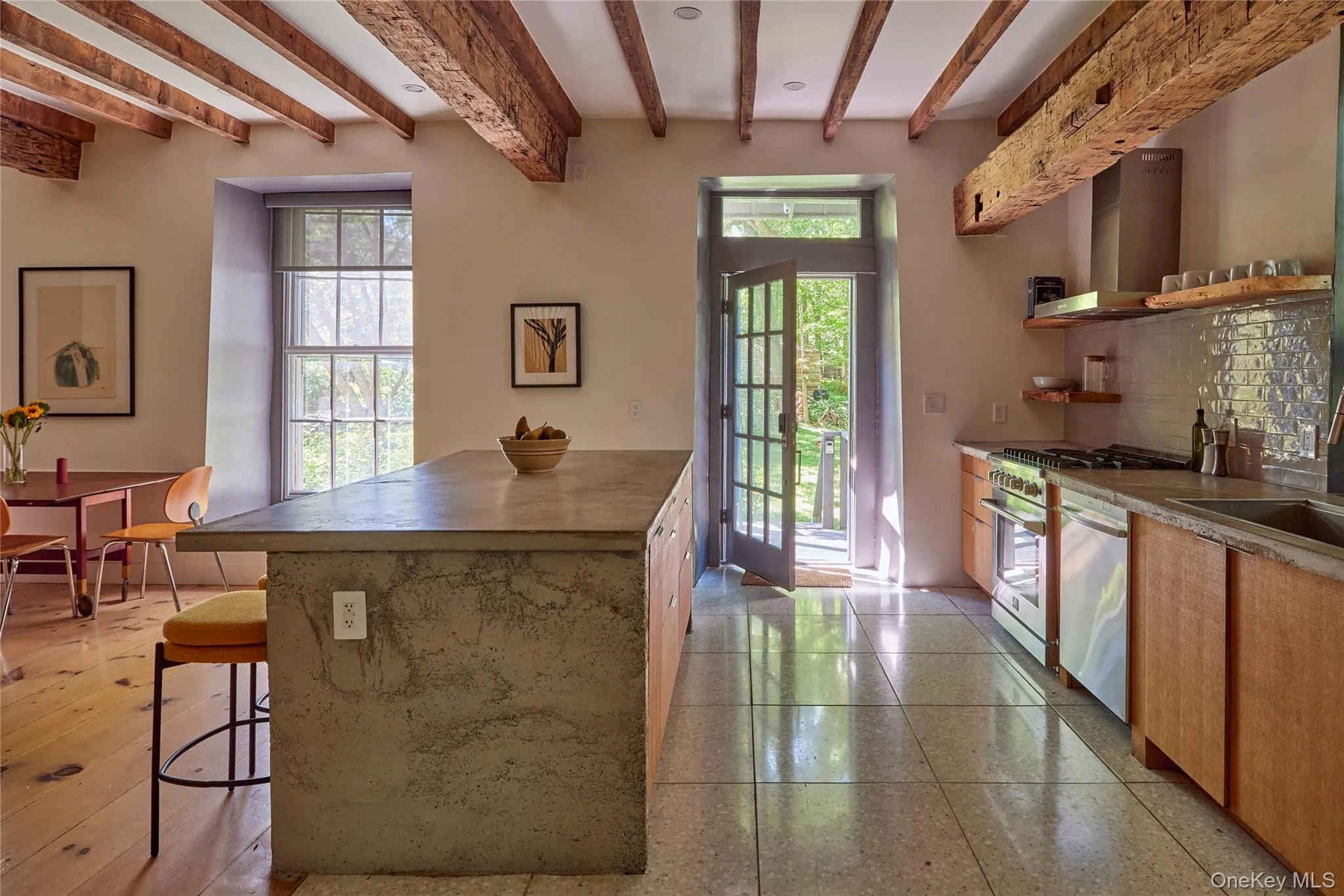 Kitchen with open shelves, wall chimney exhaust hood, backsplash, a breakfast bar area, and beam ceiling Kitchen with open shelves, wall chimney exhaust hood, backsplash, a breakfast bar area, and beam ceiling
