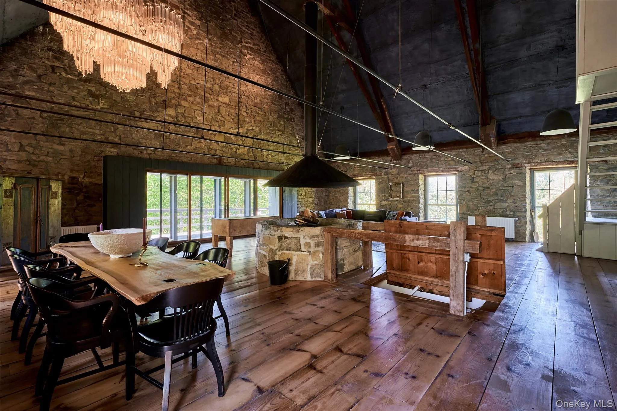 Dining space with hardwood / wood-style flooring, a high ceiling, and plenty of natural light Dining space with hardwood / wood-style flooring, a high ceiling, and plenty of natural light