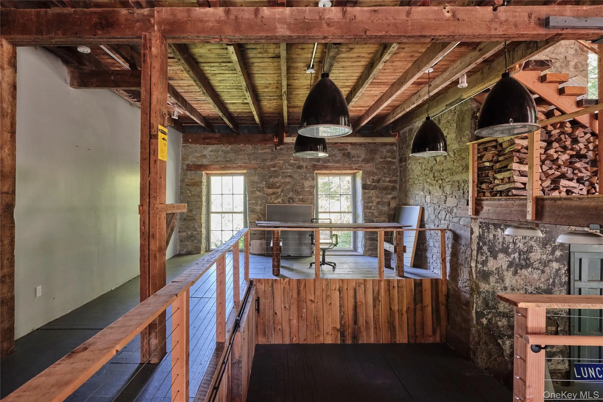 Hallway featuring a wood ceiling with exposed beams, an upstairs landing, and dark wood finished floors Hallway featuring a wood ceiling with exposed beams, an upstairs landing, and dark wood finished floors