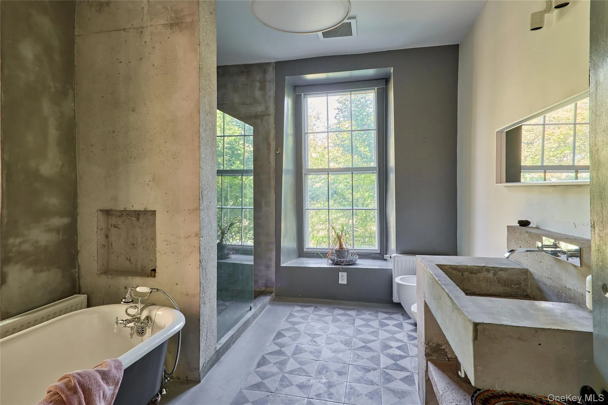 Full bath featuring a freestanding tub, vanity, light flooring, and a stall shower Full bath featuring a freestanding tub, vanity, light flooring, and a stall shower