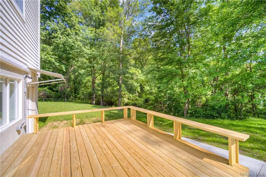 Wooden deck featuring a yard Wooden deck featuring a yard