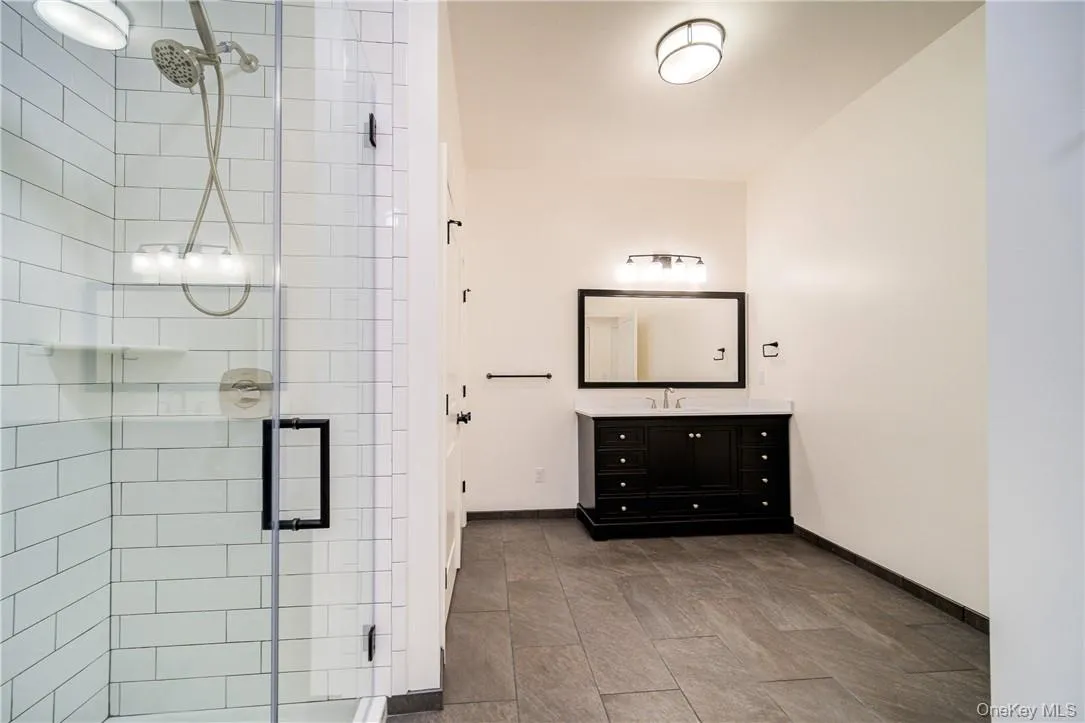 Bathroom with tile floors, an enclosed shower, and vanity Bathroom with tile floors, an enclosed shower, and vanity