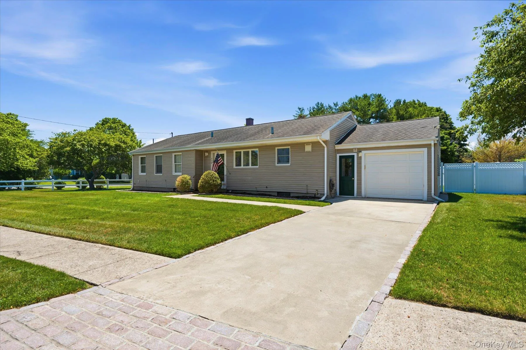 Front of home with Cement Driveway and Sidewalk lined street Front of home with Cement Driveway and Sidewalk lined street