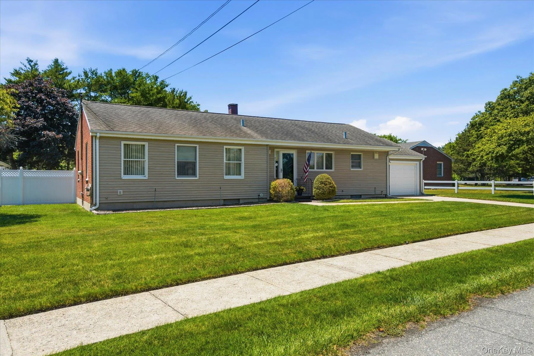 Front of home with Cement Driveway and Sidewalk lined street Front of home with Cement Driveway and Sidewalk lined street