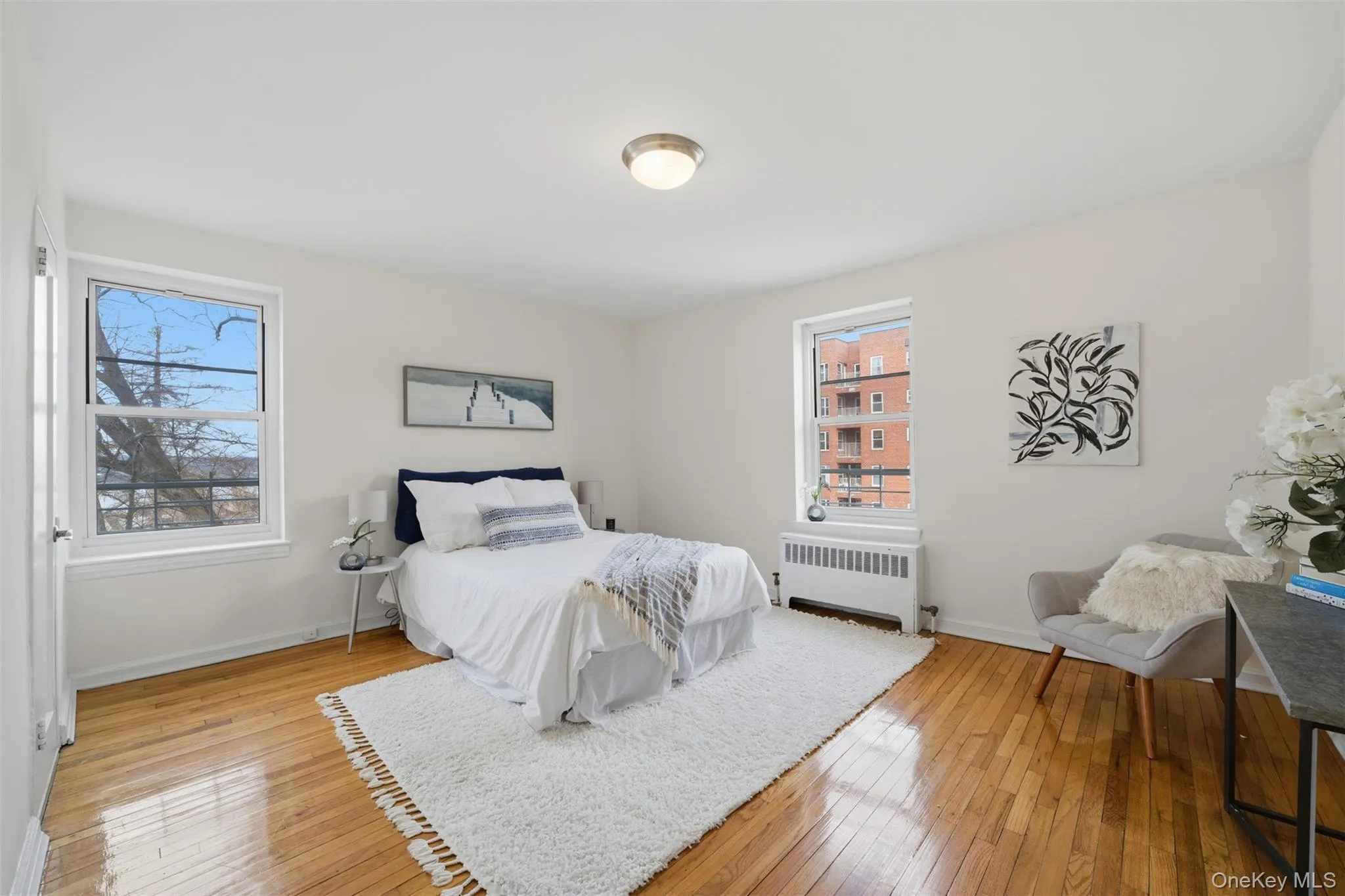 Spacious primary bedroom with two windows, including one overlooking the Hudson River, hardwood floors, and a private en-suite bathroom. Spacious primary bedroom with two windows, including one overlooking the Hudson River, hardwood floors, and a private en-suite bathroom.