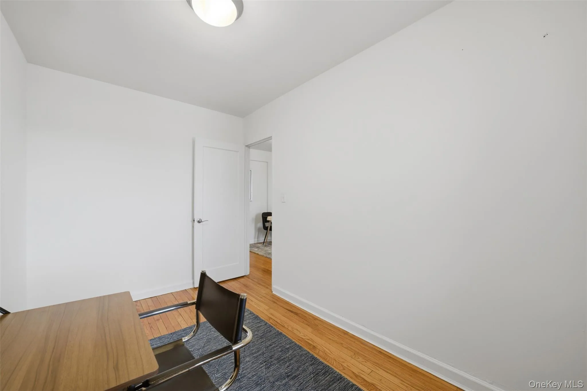 Bedroom with hardwood floors and a window overlooking the Hudson River, offering flexible use options. Bedroom with hardwood floors and a window overlooking the Hudson River, offering flexible use options.