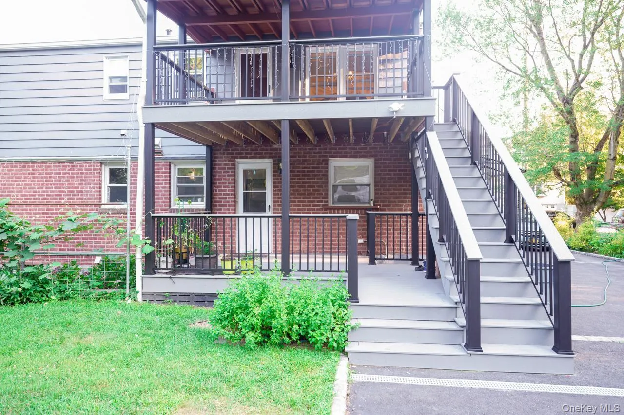 Rear view of house with a yard and brick siding Rear view of house with a yard and brick siding