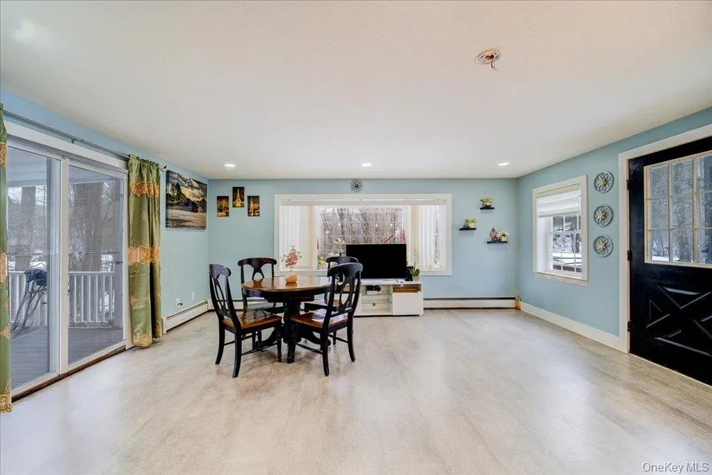 An open-concept kitchen seamlessly connects to a cozy enclosed porch, creating the perfect space for family gatherings and entertaining. An open-concept kitchen seamlessly connects to a cozy enclosed porch, creating the perfect space for family gatherings and entertaining.