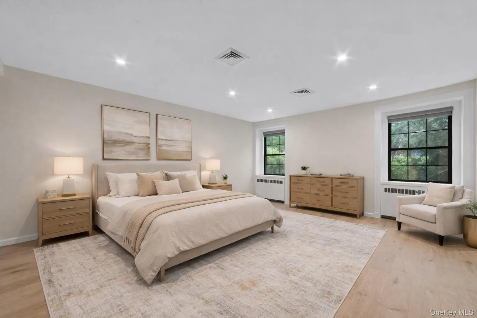 Spacious and bright primary suite with all new hardwood floors - virtually staged Spacious and bright primary suite with all new hardwood floors - virtually staged