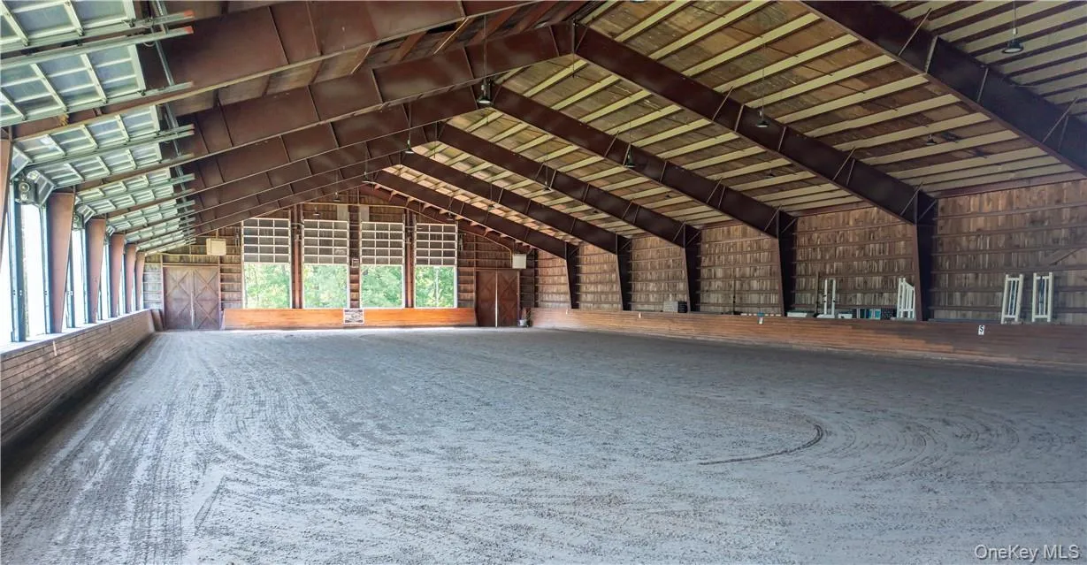 An attached 200' x 90' indoor riding ring with equestrian sand with fiber footing, sound system, and retractable windows. An attached 200' x 90' indoor riding ring with equestrian sand with fiber footing, sound system, and retractable windows.