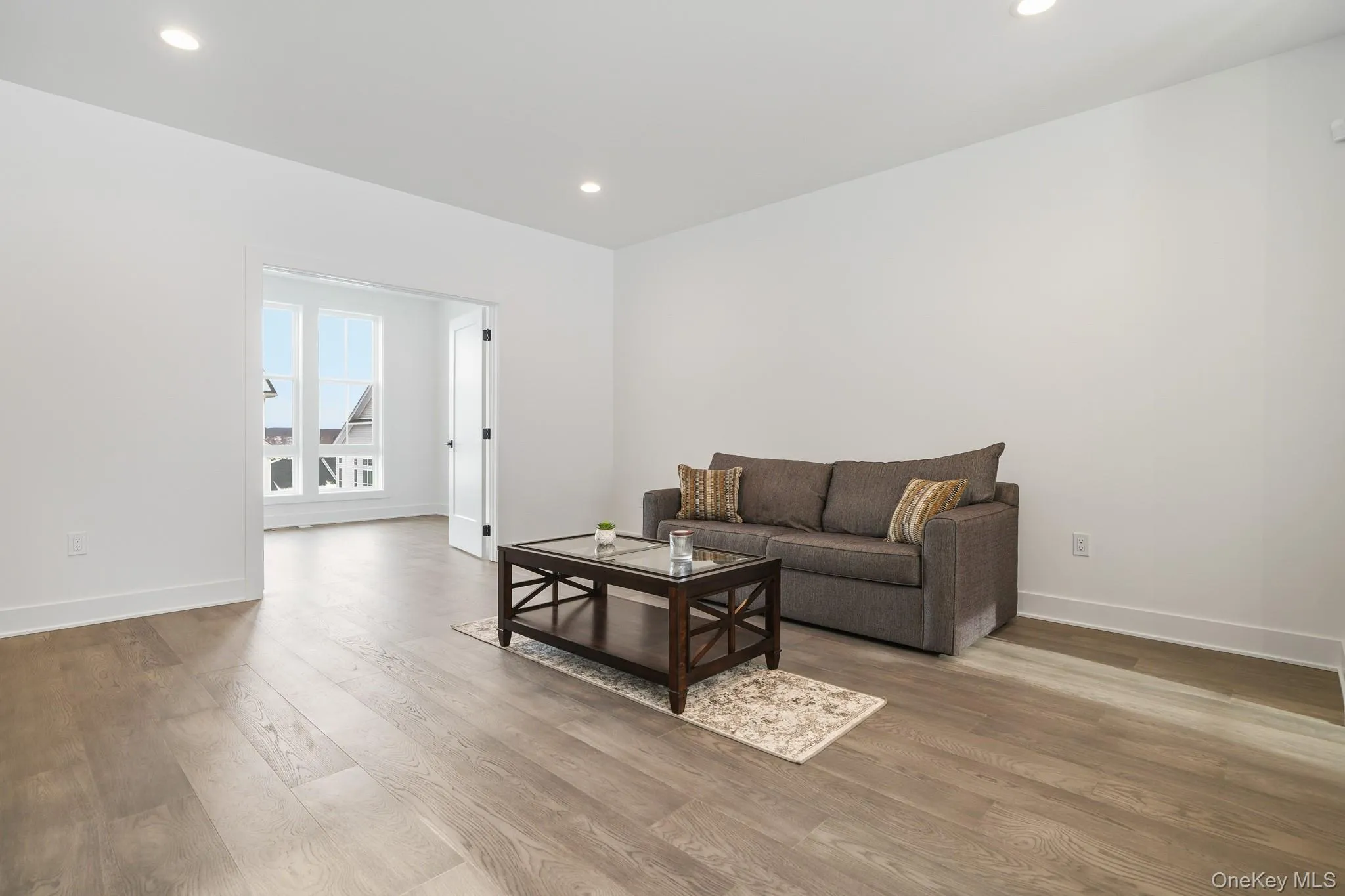 Living room featuring recessed lighting and light wood-style flooring Living room featuring recessed lighting and light wood-style flooring