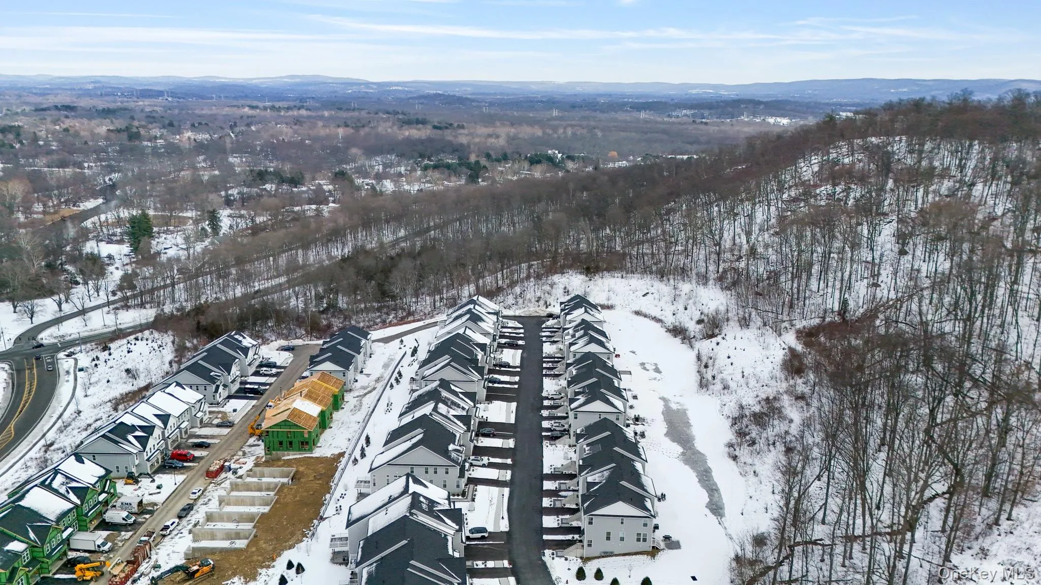 Snowy aerial view featuring a mountain view Snowy aerial view featuring a mountain view