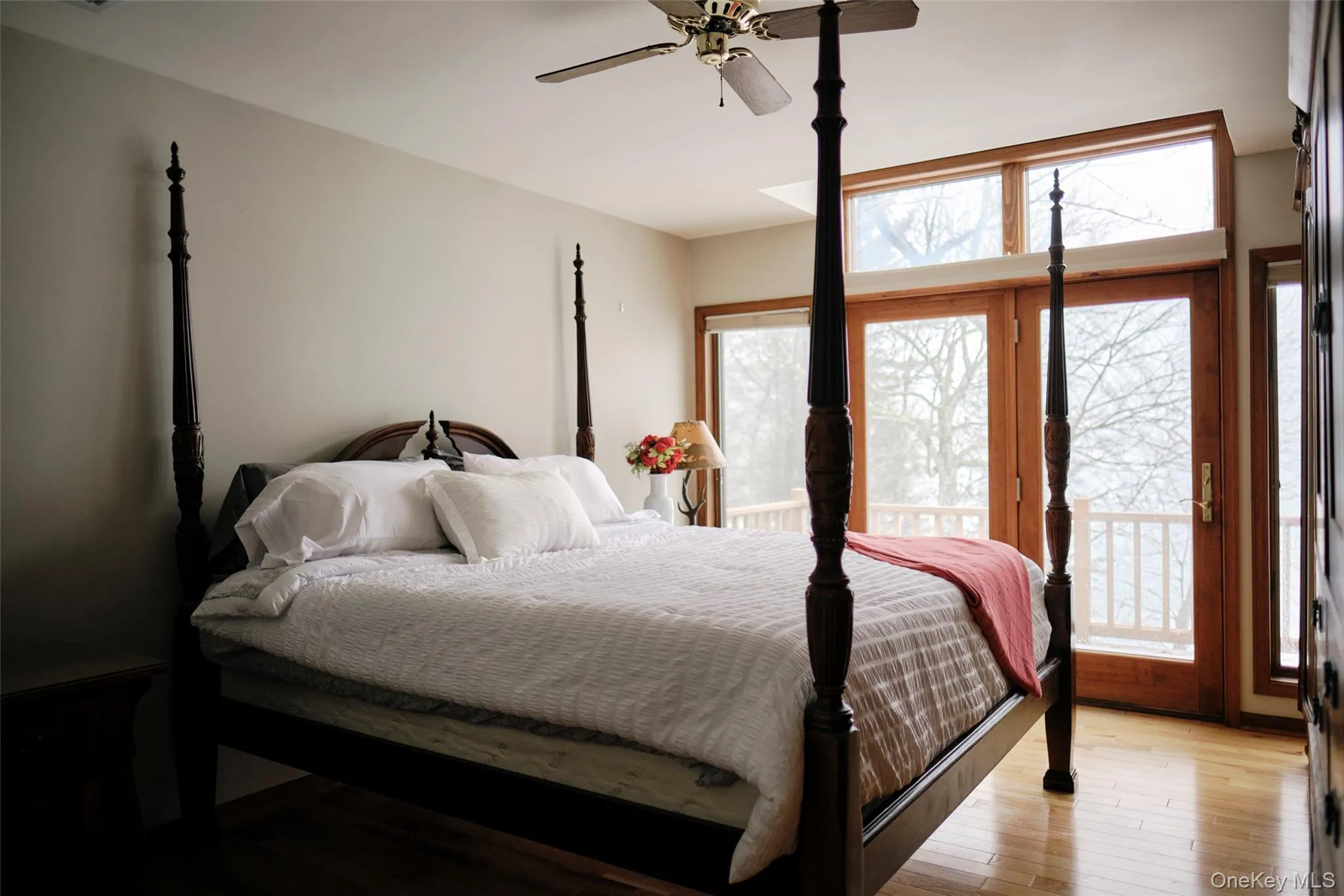 Primary bedroom featuring a balcony with lakeview Primary bedroom featuring a balcony with lakeview