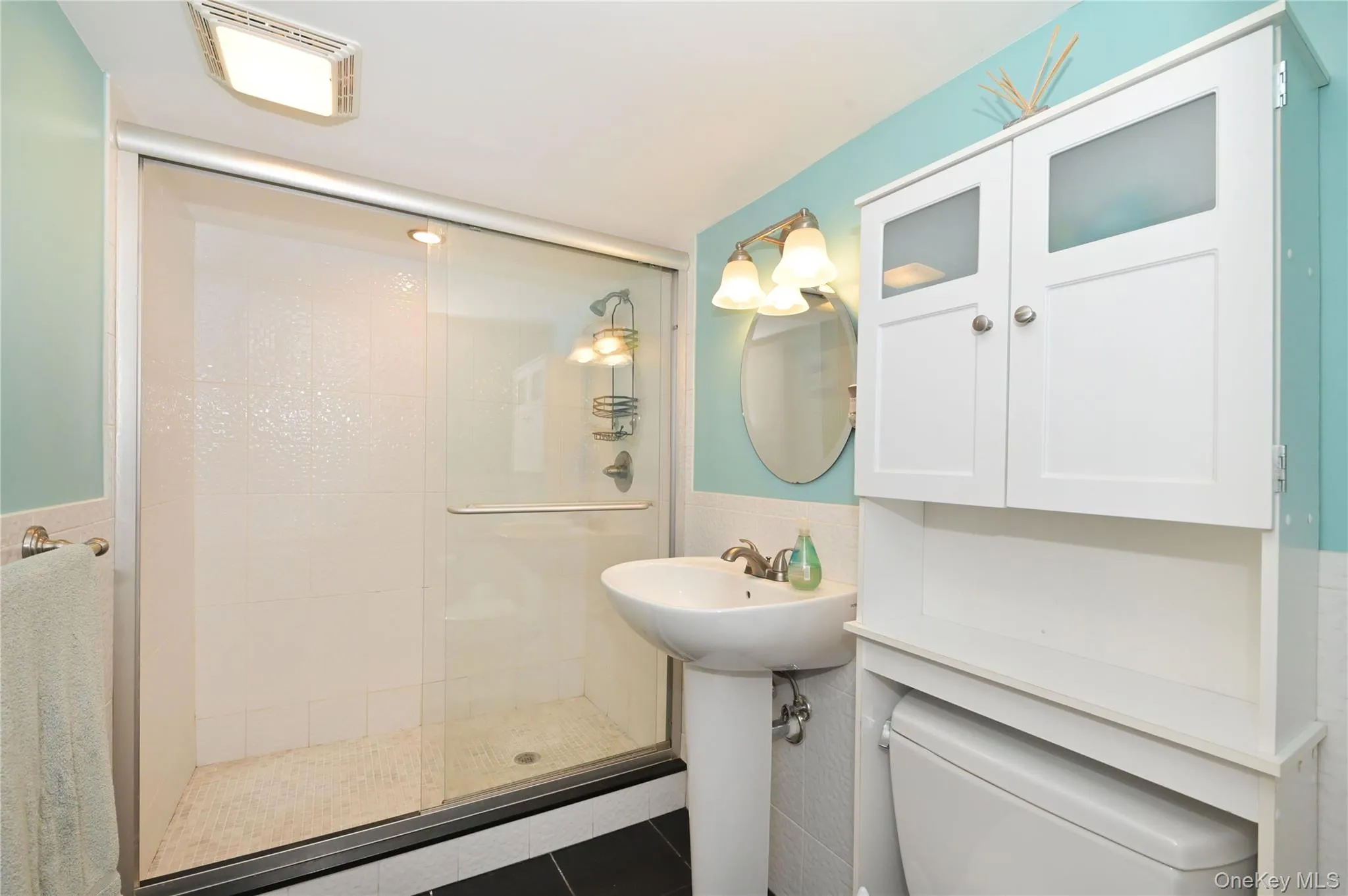 Full bath with a stall shower, and tile walls Full bath with a stall shower, and tile walls