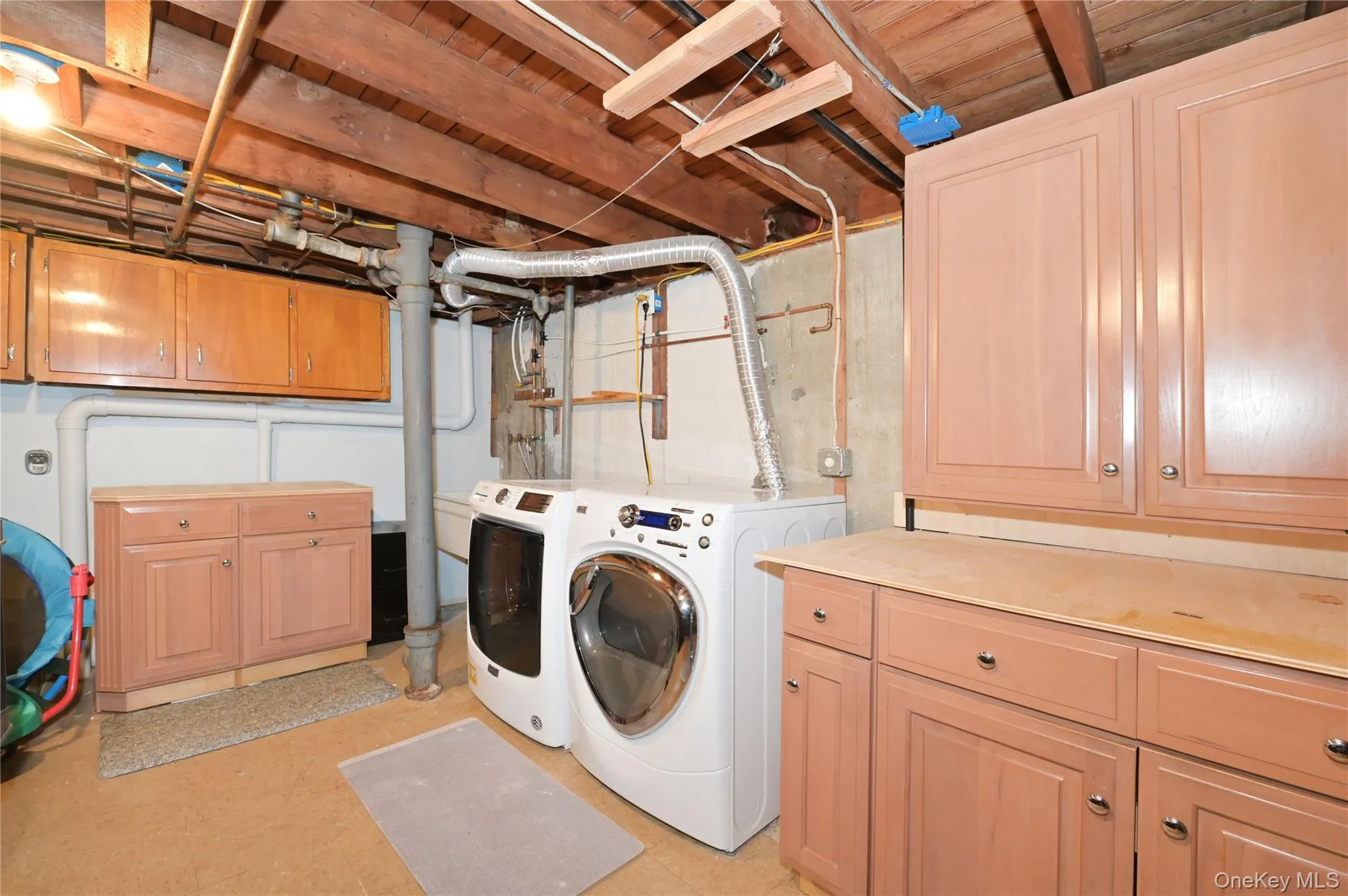 Laundry room with cabinet space and separate washer and dryer Laundry room with cabinet space and separate washer and dryer
