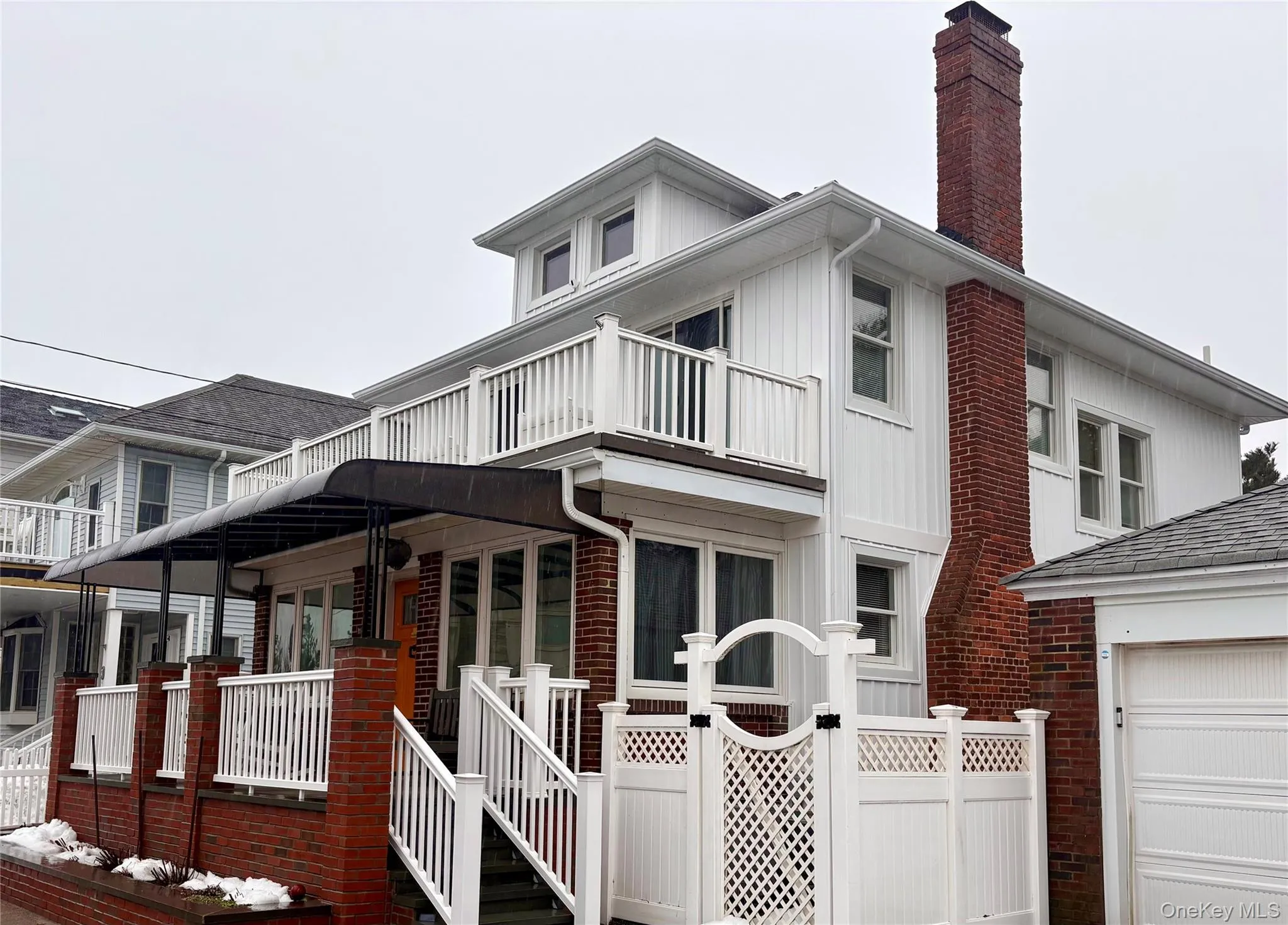 New Board & Batten siding and new brick front porch with awning New Board & Batten siding and new brick front porch with awning