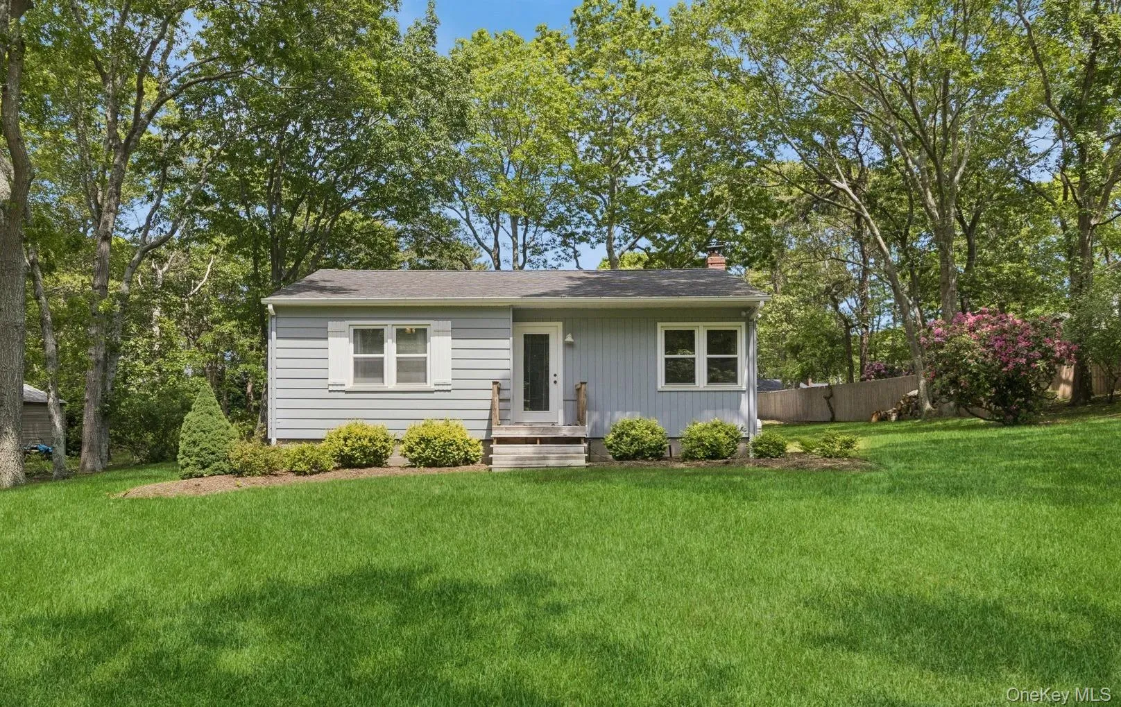 View of front of home with a chimney, a front yard, and a shingled roof View of front of home with a chimney, a front yard, and a shingled roof
