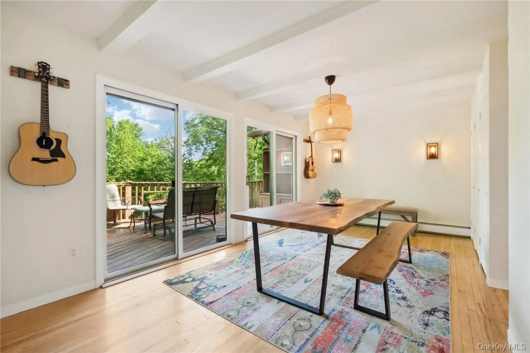 Dining room with beam ceiling and light wood-type flooring Dining room with beam ceiling and light wood-type flooring
