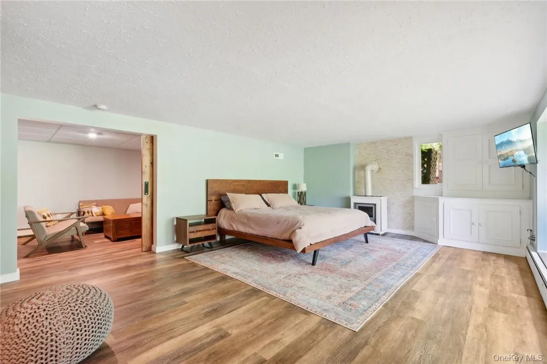 Bedroom with a textured ceiling and wood-type flooring Bedroom with a textured ceiling and wood-type flooring