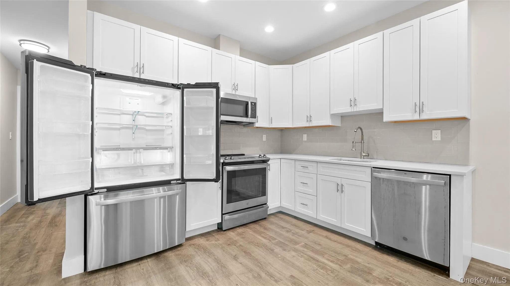 This kitchen features stainless steel appliances, great cabinet space and natural quartz countertops. This kitchen features stainless steel appliances, great cabinet space and natural quartz countertops.