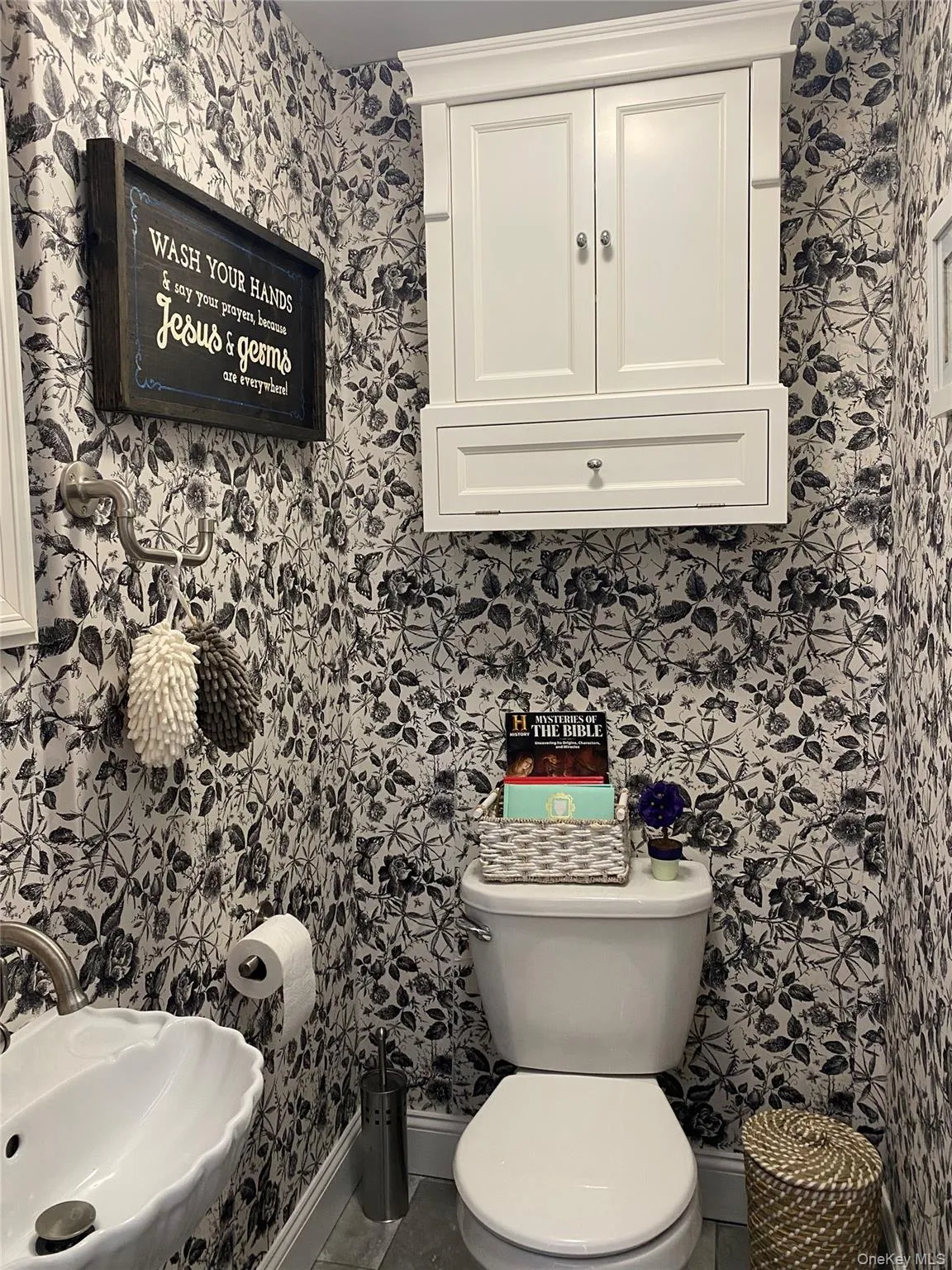 Bathroom featuring wallpapered walls Bathroom featuring wallpapered walls