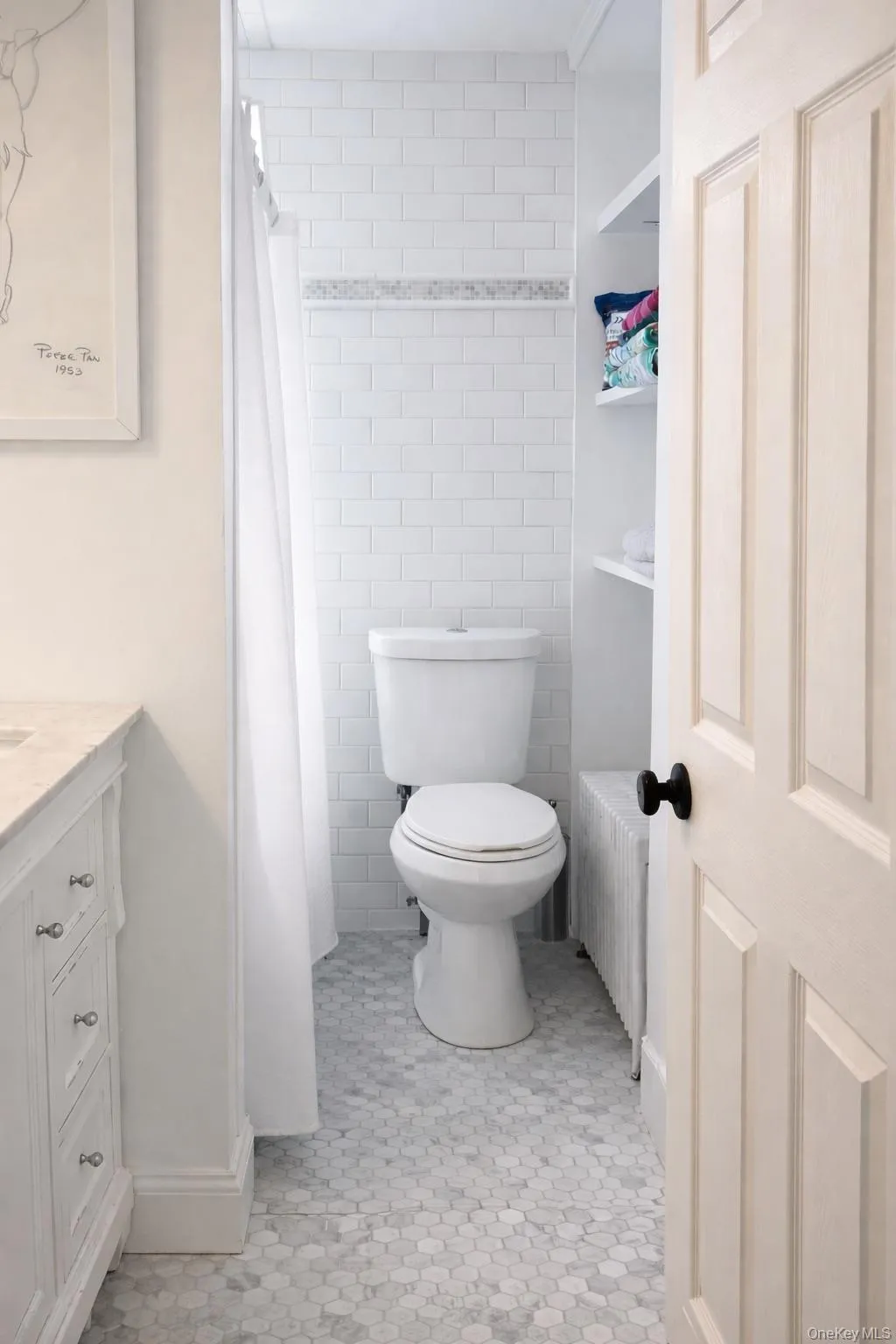 Bathroom with tile walls, vanity, and a shower with shower curtain Bathroom with tile walls, vanity, and a shower with shower curtain