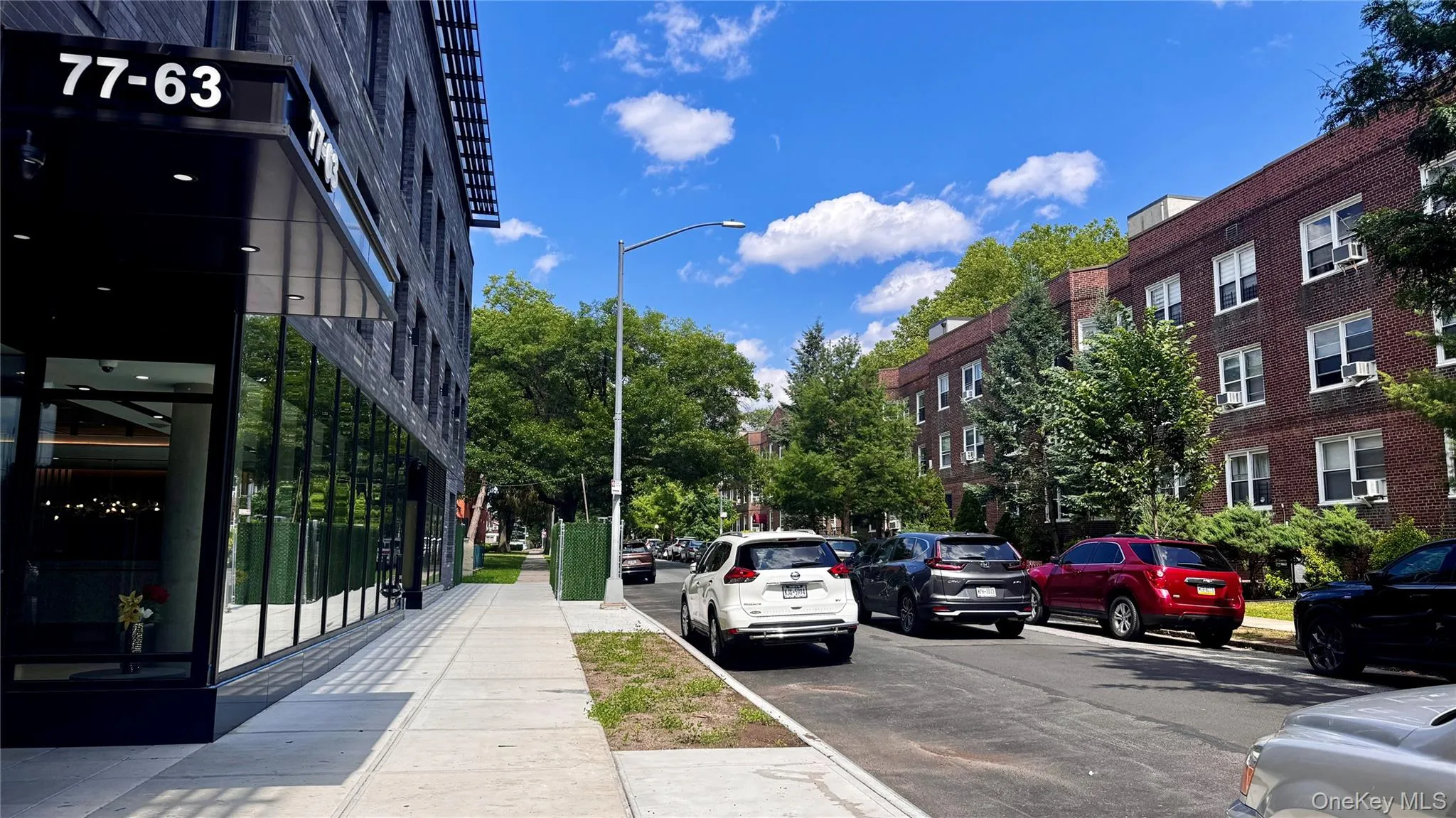 View of asphalt street with street lighting, sidewalks, and curbs View of asphalt street with street lighting, sidewalks, and curbs