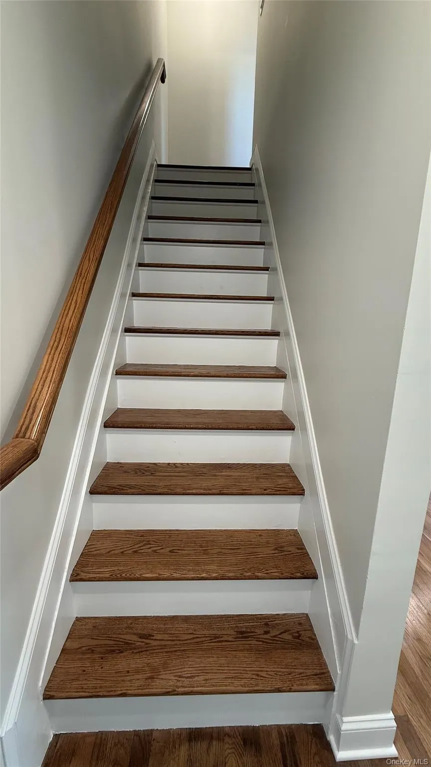 Staircase featuring wood finished floors leading to the second floor Staircase featuring wood finished floors leading to the second floor