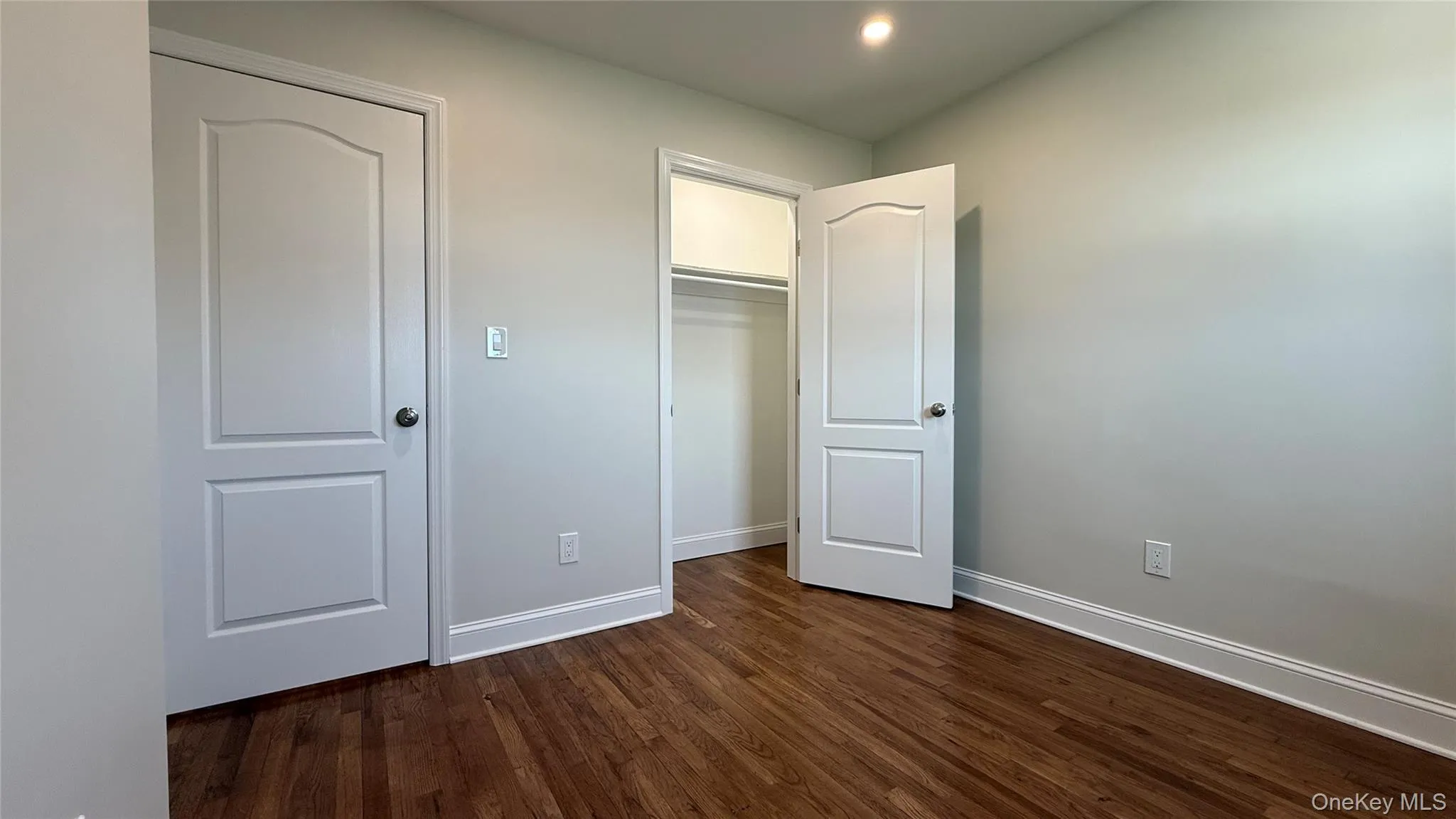 Bedroom (2) featuring recessed lighting, dark wood-style flooring, and a closet Bedroom (2) featuring recessed lighting, dark wood-style flooring, and a closet