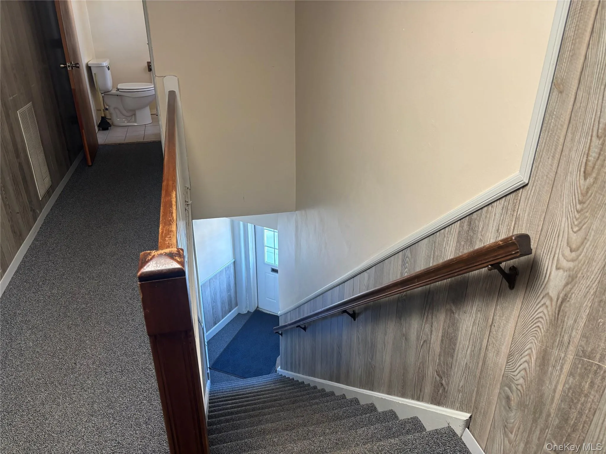 Stairs leading to office and view of bathroom in the hallway. Stairs leading to office and view of bathroom in the hallway.