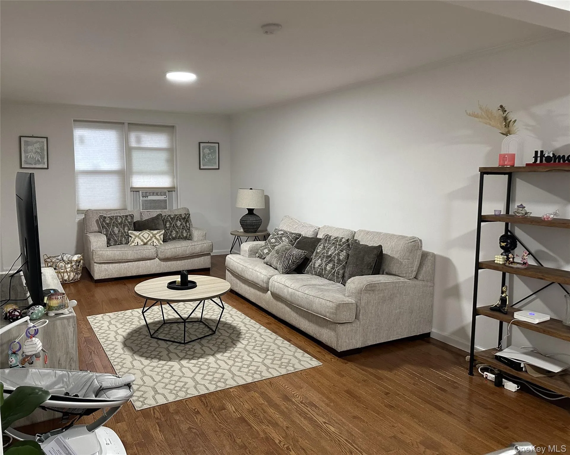 Living area with wood finished floors, recessed lighting, and cooling unit Living area with wood finished floors, recessed lighting, and cooling unit