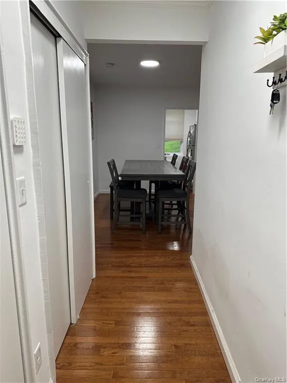 Hallway with wood-type flooring and baseboards Hallway with wood-type flooring and baseboards